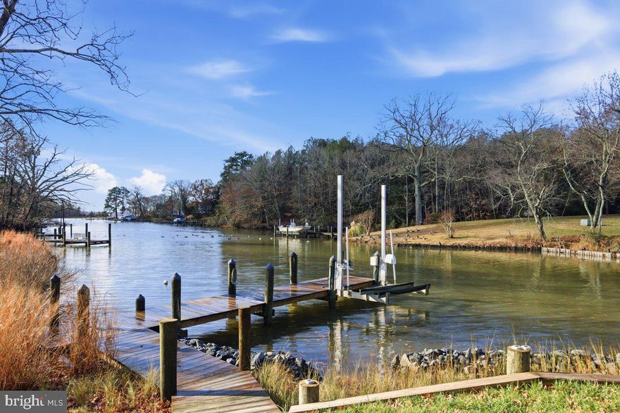 EXPANSIVE WATER VIEWS WITH LARGE WINDOWS! Looking for the perfect single-story waterfront escape? Whether you’re dreaming of a serene weekend retreat or a charming full-time residence, this property checks every box. With no HOA and a location just minutes from renowned Solomons Island, you’ll enjoy both freedom and convenience. It’s ideal for commuting to PAX or even DC, and you're only moments away from local shops, restaurants, and the beloved Tiki Bar.
Brand new private pier with an electric boat lift.  A detached garage with a newer door provides protected parking and ample storage for fishing gear, crab pots, a boat trailer, and more.