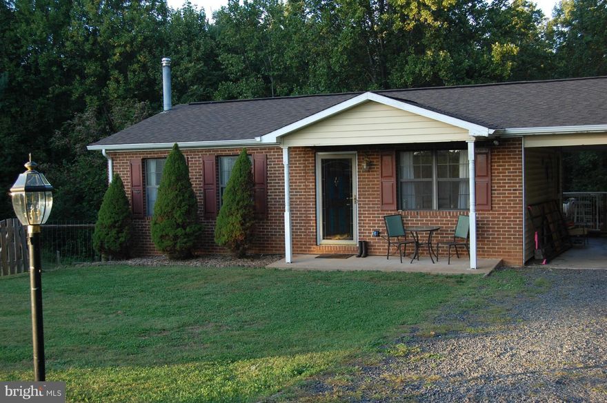 ADORABLE HOME, NEAT AS A PIN AND MOVE IN READY.  THIS HOME OFFERS A BEAUTIFUL LOT WITH TREES FOR PRIVACY. IN THE COUNTRY BUT ONLY 6+ MILES TO TOWN.   BOTH LEVELS FULLY FINISHED, LOWER LEVEL W/O LEVEL TO BACKYARD. NICE KITCHEN WITH DOORS LEADING TO CARPORT & BACK DECK. FENCED YARD FOR PETS WITH DOGGY DOOR ACCESS TO HOME. 2 BR'S, 3RD BR OWNER USES AS SITING AREA BUT WILL CONVERT BACK. COME SEE.