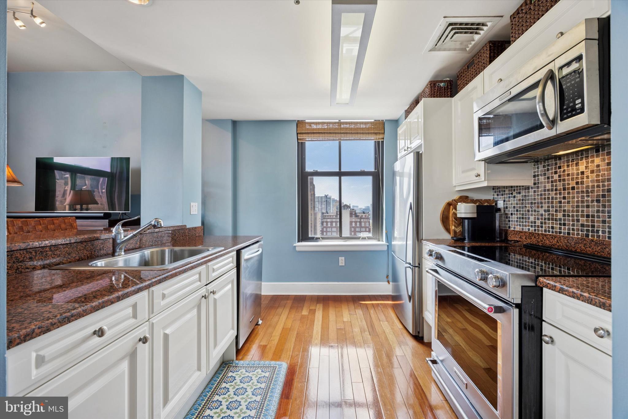 Sleek corner condo with skyline views in the heart of Center City, perfectly positioned just steps from City Hall and a short stroll to Rittenhouse Square, offering a bright and airy 2-bedroom, 2-bath layout with a fresh blend of style, comfort, and convenience. Perched high above the city in a secure, amenity-rich building, the home is flooded with natural light from oversized southern and western windows—without a single mechanical view in sight. Soaring ceilings and an open layout create a sense of space and flow that’s perfect for both entertaining and everyday living. The primary suite boasts two double-wide closets and a beautifully updated marble-tiled ensuite bath, while the versatile second bedroom is ideal for guests, a home office, or creative pursuits. Additional features include in-unit laundry, a large pantry closet, and plenty of storage, with modern wood finishes, stainless steel appliances, and clean, contemporary design throughout. Amenities make city living a breeze, including 24-hour front desk security, package receiving, a fitness center, and a resident lounge, with storage lockers (for a small additional fee) and bike storage available. Discounted valet parking is right around the corner—just text ahead and your car is ready when you arrive! The location is unbeatable, moments from Suburban Station, 30th Street Station, Drexel University, and top hospitals, and steps from award-winning dining, upscale shopping, the Avenue of the Arts, and the city’s most beloved green spaces. Pet-friendly and perfectly placed, this condo is ideal as a full-time residence or a chic pied-à -terre—live above it all and have the city at your feet.