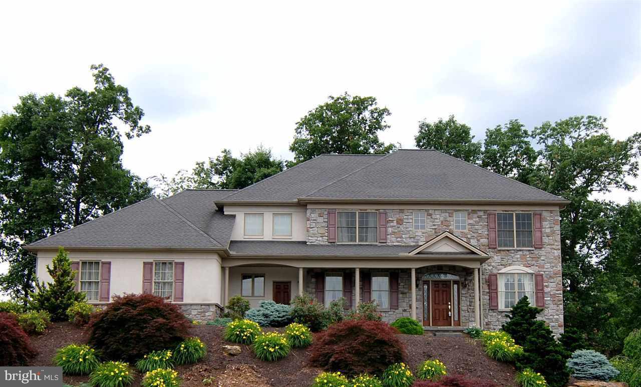 Understated Elegance, designed w/open light-filled spaces, this home is a stunning departure from the ordinary. 2 Sty Foyer, Brazilian Cherry hdwd flrs throughout the 1st flr. Formal LR, DR. Gourmet eat-in Kitch w/Granite countertops & Cherry cabinetry opens to Sun Room overlooking private rear yard. Family Rm w/Gas FP. 1st Flr Laundry. Finished Lower Level w/BR 5, FB, Family/Rec Room; walk-out to rear yard. Great for Entertaining!
