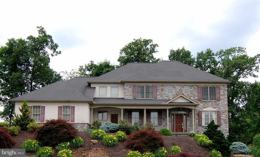 Understated Elegance, designed w/open light-filled spaces, this home is a stunning departure from the ordinary.  2 Sty Foyer, Brazilian Cherry hdwd flrs throughout the 1st flr.  Formal LR, DR. Gourmet eat-in Kitch w/Granite countertops & Cherry cabinetry opens to Sun Room overlooking private rear yard. Family Rm w/Gas FP. 1st Flr Laundry. Finished Lower Level w/BR 5, FB, Family/Rec Room; walk-out to rear yard. Great for Entertaining!