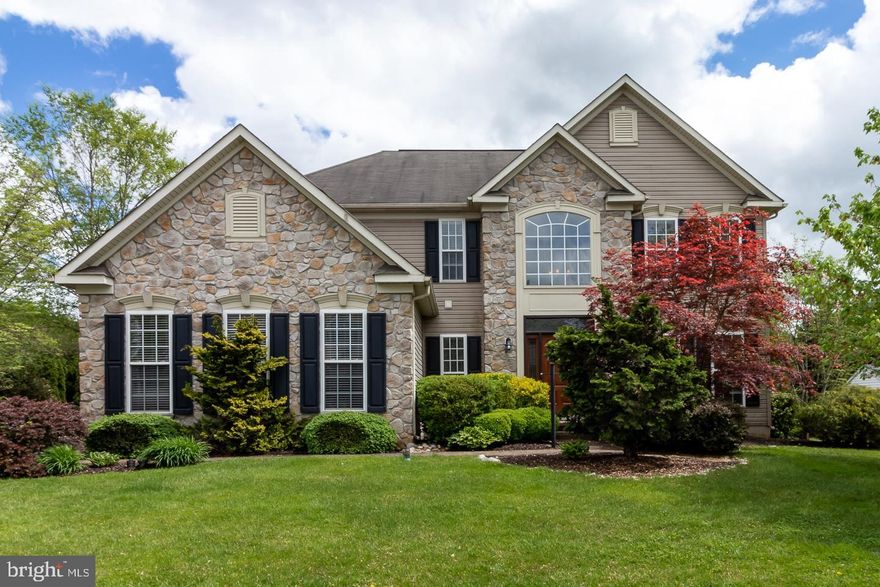 This is the home you’ve been waiting for! This 4BR 2.5 BA Avon Grove school district home has an open floor plan and an upscale stylish decor that will move you in immediately. A stately stone façade and mature landscaping welcomes you up the meandering front path, into this classic home with soaring foyer, dramatic staircase, and open concept floor plan. A rich cherry and granite eat-in kitchen is situated at the heart of the home, and offers “miles” of counter space, a huge central seated island, hardwood floor, built in gas cooking, French door refrigerator, dishwasher, spacious stainless steel sink with custom faucet, a work center and pantry, and flows easily to the sunny breakfast room surrounded by floor to ceiling windows with views to the custom patio and private rear yard. The large family room features a gas fireplace with glass doors and is perfect for entertaining, with French doors to a first floor office. The first floor also includes a formal dining room (currently used as an office) and formal living room with hardwood floors, a powder room with hardwood floors and pedestal sink, laundry/mud room, and interior access to the oversized 2-car garage. The second floor features a primary bedroom sanctuary in soothing tones with spa like en suite bathroom boasting double sink vanity, new tiled floor, new stylish soaking tub with custom floor mounted faucet, glass stall shower, and water closet.  Three additional spacious bedrooms and a full hall bath complete the second level. The partially finished basement allows for additional family or rec space and has plenty of additional storage space.  The rear yard is amazing, with custom paver patio with hardscape curved wall with lighting. This is an impeccable home with great floor plan flow and space, a luxurious private back yard, and with a fantastic curb appeal.  Close to schools, shopping, and commuter routes, this house is literally move in ready and a must-see!