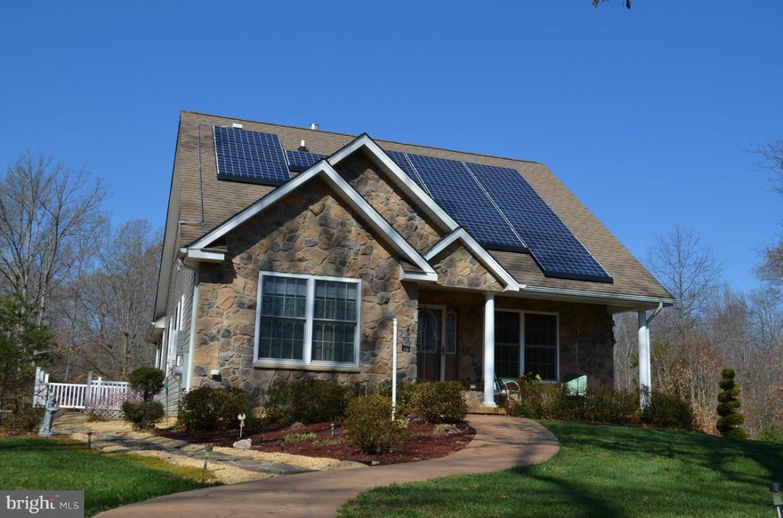 Beautiful custom built home on almost 22 wooded acres w/cleared trails. Stone front, stamped concrete,solar panels, geothermal heat, custom built hickory kit'n cabinets, hrdwd floors, dura-ceramic tile in kit'n, sun rm w/stone wall/stamped concrete, dble doors on all bdrms. 2 car det. garage w/elec & another 1 car detached garage w/elec & carport. Shows like a model, don't miss out on this beauty!