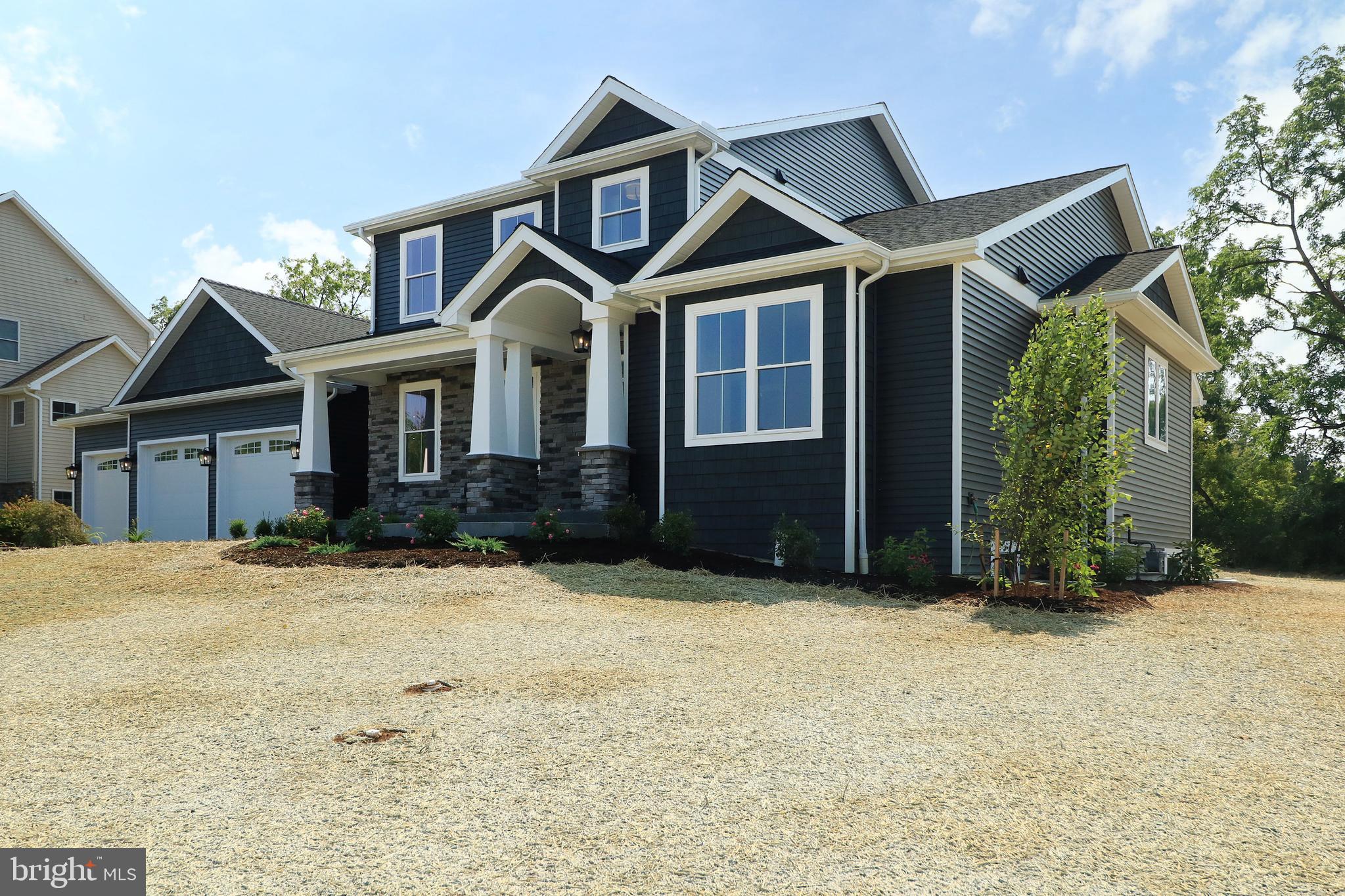Welcome to 124 Primrose Court in sought-after Stearns Crossing! Just completed, this custom-built GEM Homes craftsman style home boasts high end finishes, nine foot first floor ceiling height, 5 bedrooms, 4.5 baths, and over 3600+ square feet and features a main floor primary suite. Enter from the stamped concrete front porch with barrel ceiling into abundant white oak hardwood flooring that flows throughout the main floor, up the stairs & upstairs hallway, and into the 2nd floor secondary suite. You'll love the plentiful windows throughout and the large sliding doors in the great room letting in an abundance of natural light. The impressive luxury kitchen features custom, handmade solid-wood white mission style cabinetry with upper lighted glass cabinets stretching to the ceiling, a large walnut island with cabinets on both sides and a large breakfast bar, quartz countertops, GE Cafe series stainless steel appliances including a 48" 6 burner gas cooktop with pot-filler, a double oven, a tiled backsplash, undercabinet, pendant, and recessed lighting, and a huge walk-in pantry boasting a mix of custom Amish-made cabinetry, solid shelving, a quartz countertop, and a drawer microwave. The sizable dining room with crown molding, chair rail, sconce lighting and a butler's pantry with a prep sink and beverage fridge is perfect for entertaining. The expansive family room with abundant windows and large sliders, recessed lights, a ceiling fan, a gas fireplace with stone hearth & walnut mantle, and built-in cabinets and shelving on both sides is great for relaxing or entertaining. The main floor primary bedroom boasts two walk-in closets and a beautiful luxury bath with a furniture grade white oak double sink vanity, shiplap accent walls, quartz countertop, metal framed mirrors, a free-standing soaking tub, heated tile flooring, a toilet closet, and a large tiled shower with a frameless glass door, rain shower head, hand-held sprayer, and a bench. A large first floor office, a half bath, a mudroom with a built-in bench, and a laundry room with a utility sink, custom cabinets, and a quartz countertop complete the main floor. Upstairs, you'll find a second suite boasting plentiful recessed lights and an ensuite bath with a double sink vanity and a custom tiled shower with a frameless glass door. Three additional ample-sized bedrooms and two additional full baths with Amish-made cabinetry, quartz countertops, tile floors, and tiled tub surrounds complete the second floor. The oversized three car garage provides hobby space and a utility sink while the mudroom has a built-in bench with shiplap backing and a large closet. Upgraded with two separate gas HVAC systems you'll have total control over temperatures on each floor and be comfortable throughout the house. Downstairs, the unfinished basement has nine foot ceilings, two egress windows, and full bath pre-plumbing for future finishing. Relax on the front stamped concrete porch, gather on the covered rear stamped concrete patio, or have fun on your half acre flat lot offering privacy with its mature tree line. Additional features are black bath, door and light fixtures, black metal railing balusters, solid core doors, solid closet shelving, framed bath mirrors, and tiled shower and tub surrounds throughout. A short walk to Fogleman Fields and Spring Creek Elementary, and not far from Spring Creek Park provide for plenty of recreation. Conveniently located close to Penn State, Mt. Nittany Medical Center, downtown State College and the mall area, yet tucked away in a quiet part of town. Luxury living at its best!