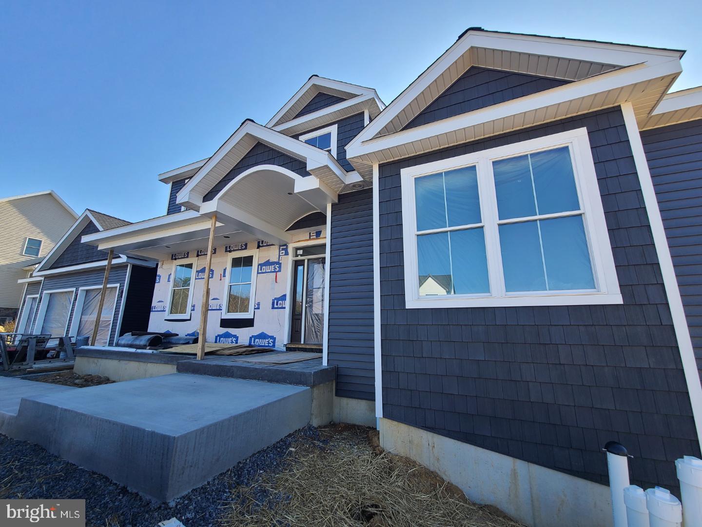 Welcome to 124 Primrose Court in sought-after Stearns Crossing! Currently under construction, this custom-built GEM Homes craftsman style home boasts high end finishes, nine foot first floor ceiling height, 5 bedrooms, 4.5 baths, and over 3600+ square feet. Enter from the stamped concrete front porch with barrel ceiling into abundant white oak hardwood flooring that flows throughout the main floor, stair treads, upstairs hallway, and the 2nd floor secondary suite. You'll love the plentiful windows throughout and the large sliding doors in the great room letting in an abundance of natural light. The impressive luxury kitchen features custom, handmade solid-wood white mission style cabinetry with upper lighted glass cabinets stretching to the ceiling, a large walnut island with cabinets on both sides and a large breakfast bar, quartz countertops, GE Cafe series stainless steel appliances including a 48" 6 burner gas cooktop with pot-filler, a double oven, a tiled backsplash, undercabinet, pendant, and recessed lighting, and a huge walk-in pantry boasting a mix of custom Amish-made cabinetry, solid shelving, a quartz countertop, and a drawer microwave. The sizable dining room with crown molding, chair rail, sconce lighting and a butler's pantry with a prep sink and beverage fridge is perfect for entertaining. The expansive family room with abundant windows and large sliders, recessed lights, a ceiling fan, a gas fireplace with stone hearth & walnut mantle, and built-in cabinets and shelving on either side is great for relaxing or entertaining. The main floor primary boasts his and hers walk-in closets and a beautiful luxury bath with a furniture grade white oak double sink vanity, shiplap accent walls, quartz countertop, metal framed mirrors, a free-standing soaking tub, heated tile floor, a toilet closet, and a large tiled shower with a frameless glass door, rain shower head, hand-held sprayer, and a bench. A large first floor office, a half bath, a mudroom with a built-in bench, and a laundry room with a utility sink, custom cabinets, and a quartz countertop complete the main floor. Upstairs, you'll find a second suite boasting plentiful recessed lights and an ensuite bath with a double sink vanity and a custom tiled shower with a frameless glass door. Three additional ample-sized bedrooms and two additional full baths with Amish-made cabinetry, quartz countertops, tile floors, and tiled tub surrounds complete the second floor. The oversized three car garage provides hobby space and a utility sink while the mudroom has a built-in bench with shiplap backing and a large closet. Upgraded with two separate gas HVAC systems you'll have total control over temperatures on each floor and be comfortable throughout the house. Downstairs, the unfinished basement has a finished staircase with white oak treads, nine foot ceilings, two egress windows, and full bath pre-plumbing for future finishing. Relax on the front stamped concrete porch, gather on the covered rear stamped concrete patio, or have fun in the half acre flat lot offering privacy with its mature tree line. Additional features are black bath, door and light fixtures, black metal railing balusters, solid core doors, solid closet shelving, framed bath mirrors, and tiled shower and tub surrounds throughout. A short walk to Fogleman Fields and Spring Creek Elementary, and not far from Spring Creek Park provide for plenty of recreation. Conveniently located close to Penn State, Mt. Nittany Medical Center, downtown State College and the mall area, yet tucked away in a quiet part of town.