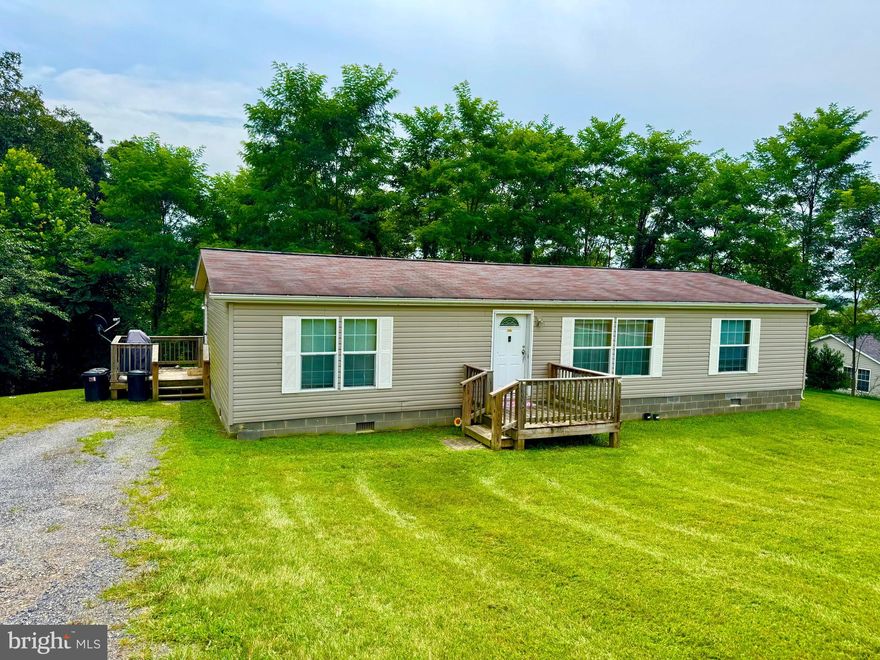 Built in 2007, this ranch-style double wide residence features three spacious bedrooms and two full bathrooms, perfect for comfortable living while nestled in the serene High Point community. The heart of the home boasts a well-equipped kitchen with modern appliances, including a dishwasher, electric oven/range, microwave, refrigerator, and convenient laundry facilities right on the main floor. Set on a generous 2.42-acre lot, enjoy the beauty of nature with partly wooded surroundings and breathtaking mountain and valley views. The outdoor space is ideal for relaxation or entertaining, with ample room for gardening or outdoor activities. A gravel driveway provides easy access and parking for up to two vehicles. This home offers a perfect blend of comfort and tranquility, making it an ideal retreat for those seeking a peaceful lifestyle. Embrace the opportunity to create lasting memories in this delightful setting and stunning view!