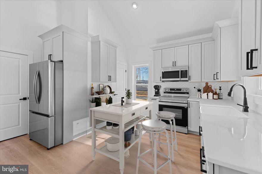 Experience refined living in this beautifully designed new-construction two bedroom, two full bath home, where timeless finishes meet modern comfort in a thoughtfully crafted open floor plan. Built with quality in mind, the home features durable 2x6 exterior framing, interior wall insulation, and comprehensive blown-in insulation for enhanced efficiency and comfort. The stunning great room is designed to seamlessly accommodate both living and dining, highlighted by soaring vaulted ceilings, a dramatic celestial window, and an abundance of natural light. Elegant picture-frame molding, gracefully capped with a chair rail, along with a subtle shiplap accent wall, adds architectural sophistication and sets a tone of understated luxury, while solid wood trim throughout the home further elevates the craftsmanship. Flowing effortlessly from the great room, the impeccably appointed kitchen is both beautiful and functional, featuring sleek quartz countertops, a striking herringbone backsplash, stainless steel appliances, and a show-stopping farmhouse sink. Forty-two-inch dove-gray cabinetry, a pantry, and direct access to a utility/mudroom complete this designer-inspired space. The home’s exquisite molding continues down the main hallway, leading to a versatile flex room on the first floor, ideal for a home office, creative studio, or hobby space. Upstairs, an unfinished bonus area with a 3/4" subfloor, accessed by pull-down stairs, offers flexible storage and future customization potential. The serene primary suite offers a walk-in closet and a beautifully finished en-suite bath, while the secondary bedroom is conveniently served by a stylish full hall bath. Luxury vinyl plank flooring and recessed lighting extend throughout the entire home, reinforcing the cohesive, polished aesthetic. Additional highlights include an encapsulated and insulated crawl space that is heated and cooled and equipped with a sump pump and dehumidifier for year-round peace of mind. Meticulously designed with exceptional attention to detail, this two-bedroom, two-bath residence delivers elevated style, comfort, and functionality for today’s buyer.