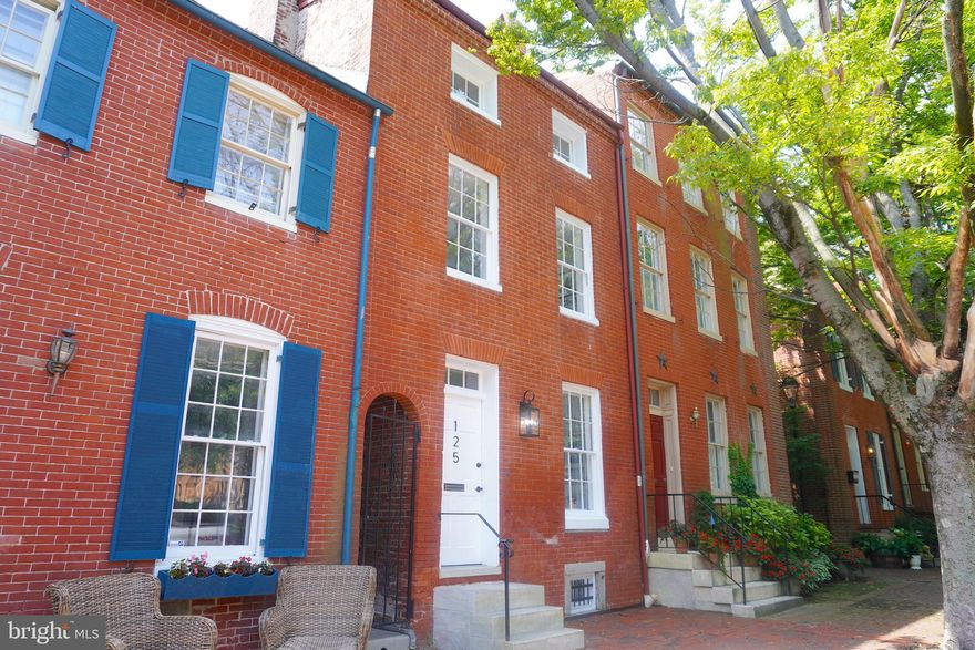 This classic Otterbein home is located two blocks to the Inner Harbor and delivers a sophisticated blend of modern comforts and classic elegance, with careful attention to detail. Incredible location near all the conveniences of the Inner Harbor with a diverse array of shops and attractions.
    Walk into the main level with hardwood floors, cozy fireplace, dining area, and half bath. Plenty of room in your bright, spacious kitchen with white cabinets, marble countertops, stainless steel appliances, and second fireplace. Perfect for coffee in the morning or entertaining friends on your rear brick patio or sunny upper deck with a view of your private yard. Walk out for a stroll in the park in the front or the back. Upstairs you will find your master bedroom with third fireplace, gorgeous en suite private bath, plus a second bedroom with another full bathroom. On the next level up, you will find two additional bedrooms each with their own  bathrooms.
   Enjoy quiet neighborhood gardens and parks around the home which serves the Otterbein community for ball tossing, dog walking, and relaxing green space. Parking is very easy on this block of the neighborhood, as it is permit-only and strongly enforced to the benefit of homeowners. Located in the heart of Otterbein, this home has easy access to I-95, the MARC train (if you happen to work in Washington, DC), Federal Hill, Camden Yards, and the Charm City Circulator. This one has it all!