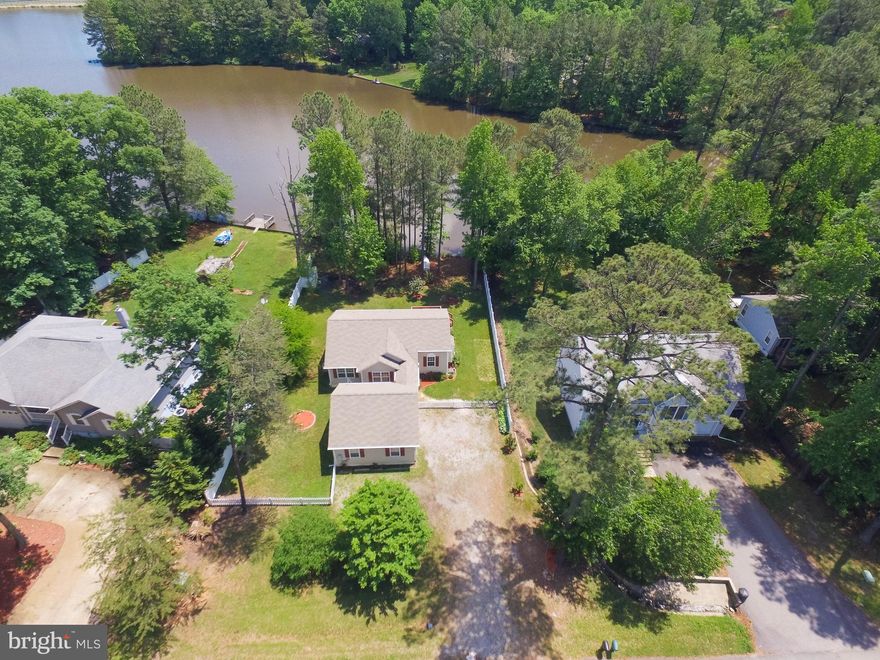 BEAUTIFUL COTTAGE STYLE HOME SETTING ON WATER FRONT, FEATURING 3 BEDROOMS 2 BATHS, LARGE 2 CAR GARAGE, FULLY FENCED YARD, CARPET IN BEDROOMS, HARDWOOD AND GAS FIREPLACE IN FAMILY ROOM, LARGE EAT-IN-KITCHEN, REAR DECK OVERLOOKING THE WATER , NICE OPEN BREEZEWAY AREA BETWEEN HOUSE & GARAGE. THE BREEZEWAY + DECK ARE WONDERFUL PLACES TO RELAX + ENJOY THE SERENITY OF THE LAKE.