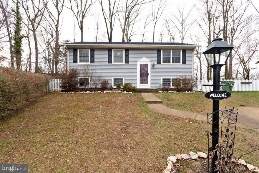 Back to Active!  An incredible opportunity to acquire this MOVE IN READY 4 bed / 2 bath split foyer home!  The main level of the home includes a living area, eat-in kitchen, 3 bedrooms & a full bath.  Paint has been refreshed throughout the upper level and the lower level bedroom.  The kitchen has been updated to include new cabinets, tile backsplash and stainless steel appliances: French door refrigerator & gas range in 2020 and Dishwasher & microwave in 2019.   The basement includes a recreation room with a wood burning fireplace, a full bathroom, large bedroom & laundry room.  From the kitchen, you step into a beautiful three season enclosed porch, a perfect area to relax and entertain.  The fenced rear yard is full of surprises with a deck area off the porch perfect for grilling, a fire pit area, and a large shed with a workbench, cabinets & plenty of space for storage --- all backing to open space for added privacy.  Uniquely situated in Lake Ridge within easy access to shops, dining, schools, and commuting routes & NO HOA!  Updates:  2020:  Refrigerator, Gas Range:  2019:   Dishwasher, Microwave, Bathroom Vanities, Flooring;  2018:   Water Heather; 2017:  Three Season Porch & Deck;  2016:  New Roof, New Siding, Trim Vinyl Wrapped; Gutter Guards Installed;  2009:  Windows Replaced;  2007:  Kitchen Remodeled;  3D walkthrough available!