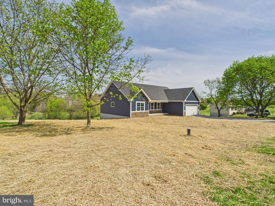 Immediate move-in available with U/O in hand! Discover the perfect blend of modern design and peaceful country living in this brand-new 3-bedroom, 2-bathroom home with UPGRADES INCLUDED! Nestled on 1.012 unrestricted acres with no HOA, this property offers the freedom to enjoy your space your way. Step inside to a bright and airy open-concept layout with vaulted ceilings, creating a spacious and inviting atmosphere. The luxury vinyl plank (LVP) flooring flows seamlessly throughout, offering durability and style. The kitchen overlooks the living and dining areas, making it ideal for entertaining. The primary suite is a private retreat with an en-suite bath, while two additional bedrooms and a full bath provide ample space for family or guests. Need more room? The unfinished basement features a rough-in for a future bathroom and two windows for future bedrooms offering endless possibilities for expansion. Enjoy nature right in your backyard, as the property backs to views of a pond, perfect for relaxing mornings or peaceful evenings. The attached 2-car garage includes a separate storage room, providing plenty of space for tools, outdoor gear, or hobbies. Don’t miss the opportunity to make it yours—schedule your tour today!