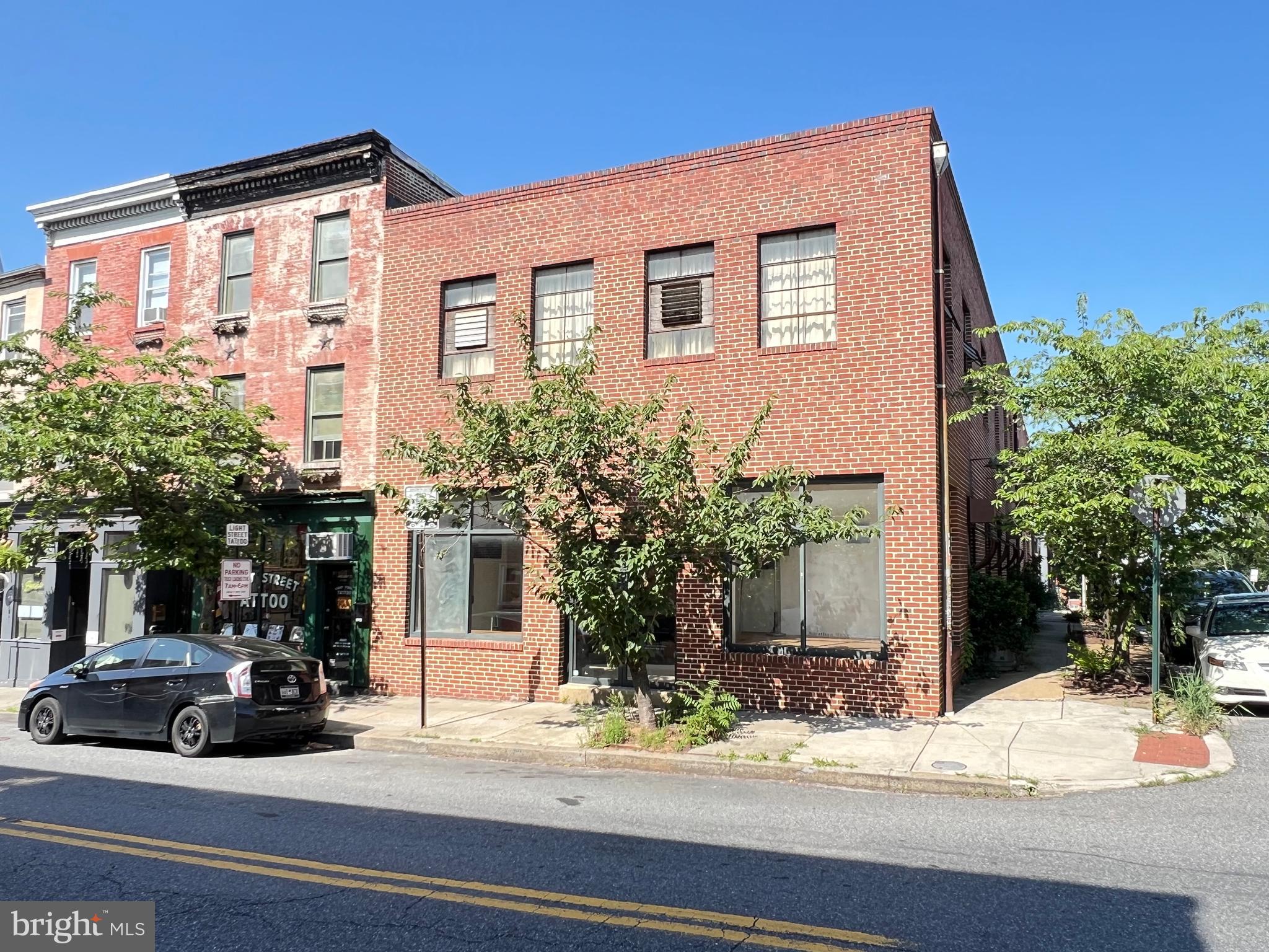 This is your Federal Hill dream property! This 11,954 sf building is a rare find and is not only huge but quite flexible for various business. Zoned C-1, this is perfect for mixed use, office, retail, restaurants, cafés, salons/spas, fitness centers, etc., and is a unique property with an attached residential dwelling housing three bedrooms and one full bathroom (a full bathroom on the main level and a half bathroom on the upper level serve the commercial spaces). The retail space is currently being used by a tattoo shop. Built-in 1952 of true brick construction with oversized steel I-beams, this building is incredibly robust and constructed when America's economy was in full bloom after World War II. The main portion of the building is being used by two separate artists and features wood floors on the upper levels. This property is on highly visible Light Street in Federal Hill, with the main level graced by 12’ tall (slightly lower on upper level) ceilings and two on-grade loading docks/garage doors with parking for three plus cars.
<br><br>
*Buyers to confirm >ALL< zoning and potential usage.* Two 2 tax IDs (one for tattoo shop and the other for the main corner building). Physical addresses are 1438-1440 Light Street. Listing agents to accompany all buyers and buyer's agents.