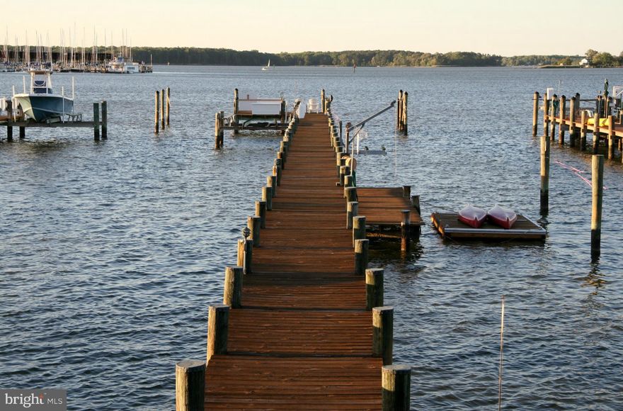 Waterfront Coastal Cottage on sought-after Chalk Point offers meticulously maintained home/grounds/pier. Enjoy an array of water sports & panoramic views in the "Land of Pleasant Living." Includes: 2 deep-water slips, 2 lifts - 10,000 lb & smaller manual, dinghy dock & 3rd slip next to floating dock.  Delight in Wednesday night sailboat races in your "front yard," a social event not to be missed.