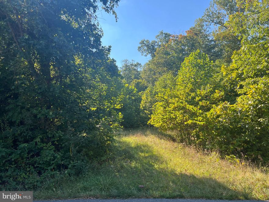 This beautifully wooded lot is conveniently located approximately 10 minutes from downtown Berkeley Springs in one direction, and Cacapon Resort State Park in the other.  Just down the road is Cold Run Valley Winery, Berkeley Springs Brewing, and Coolfont's Treetop Lounge and Restaurant. To add to the beauty of the property there is a small wet weather stream that runs through it.  With a perc test already completed and letter on file with the Health Department as well as already having a highway entrance permit, this lot is ready and waiting for you to build your dream home! The current tax bill reflects the property before it was subdivided - this property is Map 8 P/O Parcel 4.11 containing 4.9494 acres.