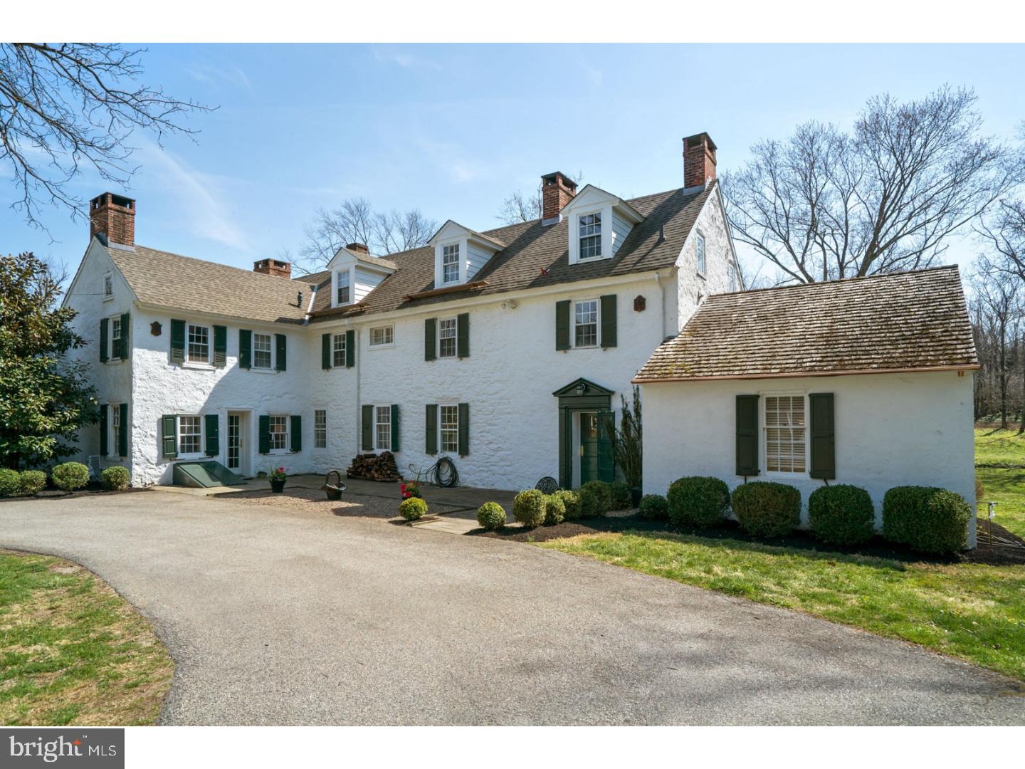 "Meadow House" is a 5,500 SF federal style home centered on eight acres near to Fort Washington State Park, Erdenheim Farm, and multiple country clubs. This elegantly remodeled three-story stone house (circa 1770s) is surrounded by meadows and tall trees with expansive views of the Cricket Club golf course. Located in historic Whitemarsh, a short drive to Chestnut Hill and the 476/PA Turnpike interchange, life in Meadow House is both bucolic and historic. Enter the property off the gold coast of Joshua Rd via a long, tree-lined driveway parallel to Lorraine's Run. Approach on the right the old working barn, a farm period relic when the estate included over 200 acres. The main foyer is the former "summer kitchen" with french doors leading to an expansive 60' terrace. Five fireplaces support a series of warm rooms large and small. The open main floor includes adjacent 20' x 40' living and 20' x 20' dining rooms with wood floors and period detailed moldings. The large living room features a gas fireplace with a federal style mantel and double french doors to the terrace, while the formal dining room comes with a wet bar and large fireplace. In winter, a modern wood stove warms the sitting room and kitchen complete with stainless steel appliances, new glass backsplash and granite countertops. In the summer months, plan to live on the outdoor porch with views of the stream and meadows. There are 5 bedrooms and 5 bathrooms. The first floor bedroom has a remodeled bath with TV and large cast iron tub. The slumber-inducing master bedroom has another federal mantel, bathroom and his/hers walk-in closets. Two more bedrooms with bath, an office with fireplace, and second floor laundry are also located on the second floor. The third floor has a bedroom, bath, yoga room, and finished attic. Finally, a separate bedroom and bath are located over the two car garage.