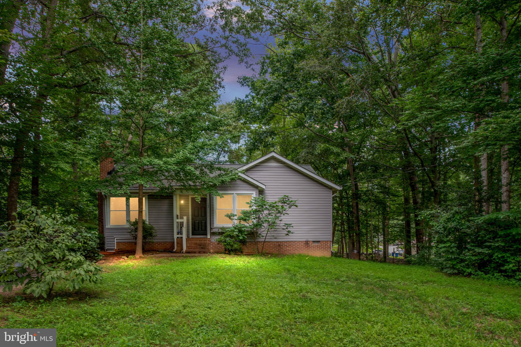 Welcome to 142 Woodland Dr, a beautifully upgraded 2-bedroom, 2-bath home nestled in a quiet, established neighborhood in Stafford, VA — with NO HOA! Step inside and you'll immediately notice the thoughtfully renovated kitchen, featuring sleek quartz countertops, an elegant tile backsplash, and updated lower cabinets, all designed to blend functionality with style. The original third bedroom wall has been removed to create a spacious open-concept dining area, perfect for entertaining or flexible living. This home has been well maintained, with a 3-year-old roof, a 4-year-old hot water heater, and an HVAC system last serviced in July 2025, offering peace of mind for years to come. Outside, enjoy a private driveway that can comfortably fit up to four cars—a rare and valuable feature in this area. Located just 10 minutes from the local high school and middle school and only one road away from the lake, this property combines convenience with tranquility. Whether you're a first-time buyer, downsizing, or looking for a low-maintenance lifestyle, 142 Woodland Dr offers comfort, updates, and location — all without the burden of HOA fees. Schedule your showing today! This is the one!