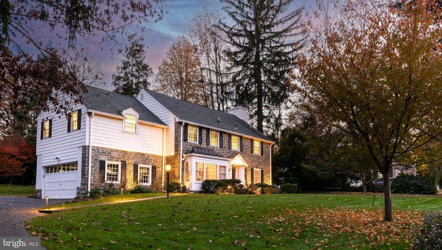 Located in a prime location, this gracious center hall stone colonial offers a perfect blend of classic charm and modern elegance. Meticulously updated, this home presents an appealing combination of timeless craftsmanship and contemporary convenience. Featuring wood floors throughout, the foyer and center hall are highlighted by traditional wainscot. Well-proportioned living and dining rooms with crown moldings and chair rail anchor the main floor. There is a den located off of the living room which is perfect for work-from-home space or a cozy retreat. The open-plan kitchen and family room is the focal point of the residence, featuring modern amenities seamlessly integrated within a classic setting. Quartz countertops, white cabinetry, and stainless steel appliances create a sophisticated chef’s kitchen with large island adjacent to the beamed family room with beautiful stone fireplace. A well-appointed family entrance with plenty of storage and an updated powder room are also found on this level. Upstairs, the house offers five beautifully appointed bedrooms, each designed with comfort and relaxation in mind. The primary bedroom is spacious and provides an en-suite updated bathroom and a large walk-in closet. There are three more large bedrooms, two with updated en-suite baths. A fifth bedroom and full bath are found on the third floor. The house has been well maintained with newer roof, updated electrical, and new furnace providing peace of mind. Stepping outside, the home unveils a private backyard—a tranquil oasis ideal for both relaxation and entertainment. The outdoor space with recently expanded and re-built flagstone patio offers a perfect retreat, allowing for moments of serenity and outdoor enjoyment. There is plenty of storage in the partially finished basement which includes a finished area perfect for a playroom or watching the game. The stone colonial residence harmoniously combines the allure of tradition with the functionality of modern living. It presents an opportunity to experience sophisticated comfort in close proximity to award-winning Lower Merion schools, public transportation, major highways, and the finest Main Line dining and shopping options.
