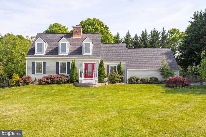 Handsome two-story, 3 bedroom, 2 1/2 bath home w/ finished basement on a lushly planted full acre in the desirable Glenn Meadows neighborhood, just a mile from historic Shepherdstown. There is a delightfully poetic, artistic essence to this well-cared-for property, plus plenty of room for all manner of outdoor activities. A wide, tree-lined driveway w/ extra parking space leads past a breathtaking weeping cherry tree and rock garden, bringing you to the front pathway to the home and to the two-car attached garage. The spacious, open front yard is perfect for recreation and boasts a beautifully crafted, semi-circular flagstone entrance patio w/ an attractive stone retaining wall. Sumptuous, beautifully planned gardens, mature shade trees, a trio of river birches, holly trees, fruit trees, blueberries, blackberries, a mature fig tree, concord grape arbor, and graceful flagstone pathways delight the senses and create a haven for birds and butterflies. You will enjoy the two-tiered entertainment decks along the rear of the home, overlooking the in-ground, two-level goldfish pond with waterfall feature, bordered by a Japanese maple and myriad shrubs and flowers. Entertain in the  fabulous custom-built, brick, peaked-roof pavilion with a large, open brick fireplace, hand-crafted stone benches, and a paver patio. Enter through the elegant front entry door with beveled glass window and sidelights where the tiled foyer and center hall w/ coat closet and guest 1/2 bath will welcome you. Tall windows w/ custom Levolor blinds ensure plenty of light in every room, with glowing wood and laminate flooring throughout the home. To the right is a wonderful family room with track lighting, ceiling fan, and garage access. To the left is the spacious formal living room w/ wood-burning fireplace, mantel & brick hearth. The light-filled separate formal dining room features two windows, as well as chair and crown molding. At the back of the home is the custom-designed kitchen with high-end details. Track lighting, contemporary open shelving, plenty of attractive white cabinetry, rustic tile flooring, ceramic cook top with downdraft ventilation, stainless appliances, wall oven, plus stunning Brazilian marble on countertops & the island, which offers storage and stainless shelving beneath. There is ample space for casual dining, with the pantry and a broom closet adding convenient storage. Double glass doors lead from the kitchen to the back decks for relaxing & entertaining and on to a flagstone pathway for gathering under the pavilion w/ its river-rock surround. A wide wooden stairway takes you to the second level of the home, offering a primary bedroom with lots of light, ceiling fan, walk-in closet, two dormers, full bath w/ warm wood cabinetry, walk-in custom-tiled shower overlooking gorgeous back gardens and trees. There are two more light-filled bedrooms w/ ceiling fans, generous closet spaces, and a full hall bath w/ tile floor, Carrara marble vanity, and dormer window. A staircase from the family room leads to the finished carpeted basement with built-in bookcases, as well as separate laundry room and utility/storage room. This sublime, beloved property is a feast for the eyes and spirit, in a peaceful neighborhood of well-established homes within a few minutes’ drive to shopping, river recreation, hiking, restaurants, a MARC commuter rail station, and renowned cultural events yr round at Shepherd University in historic Shepherdstown, WV, well-known internationally as a sought-after destination with small-town walkable appeal for the whole family.