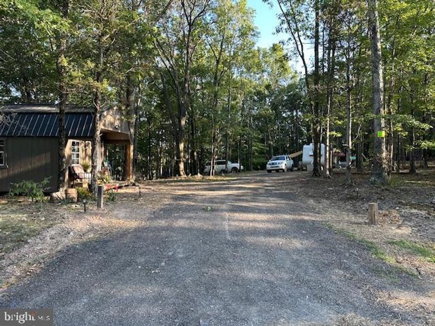 Ready to build? Look no further than this beautiful 5.25  acre parcel in the Oak Forest Subdivision in Paw Paw, WV. This lovely property has the following improvements completed:  Septic System-installed November 2023. Well drilled-December 2023.  A foundation is in place and french drains were added around the perimeter.  The Seller's plan was to build a two bedroom and one bath home and eventually expand the home adding more rooms and overall square footage according to plans she found via Dog Trot Maxhouseplans.
Electric panel, complete with lines for electric company to connect -November 2023. The well and septic hookups are accessible for an RV if one chooses to live on the property while a home is being constructed. The electrical panel has a receptacale for plugging in a generator until electric is run to the panel. All improvements have been inspected and approved by Hampshire County, and the current permit is good until April 2025. Buyer will have to transfer permit to their name. There is a small stream fed pond on the property surrounded by dogwood trees that are spectacular during spring bloom. There is also a small historic family cemetery that dates back to the 1800's. Nature abounds on this lovely sanctuary with flocks of turkey, deer, owls, fox, and much more, and is a haven for native birds of West Virginia. Just two miles away, there is river access to the Cacapon River for the kayaking enthusiasts. With a short 35 minute drive to Winchester, you will have access to dining, big box shopping, boutique stores and entertainment. The quaint town of Berkeley Springs is a 45 minute drive from the property for other dining and shopping opportunities.