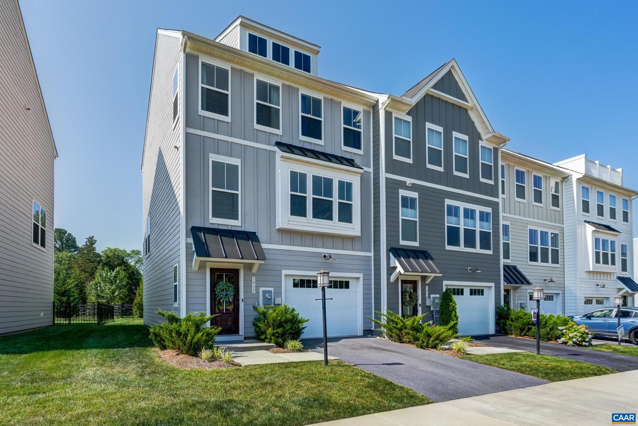 Wow! Light and bright end unit townhome in Pleasant Green! Why wait to build when you can move in today!? This community offers incredible mountain views, multiple playgrounds, basketball court, firepits and community center! This three bedroom townhome features engineered hardwood flooring on the main level and hallways, and neutral paint colors throughout the home. The main level features an open floor plan for great flow. Kitchen features white cabinets accented by a beautiful herringbone tile backsplash, stainless appliances, and granite countertops. The kitchen opens to the large dining area with accent wall, and a great room with custom-built shiplap accent wall with electric fireplace. Upstairs, the primary bedroom features two walk-in closets, and a private bathroom with shower stall. Two additional bedrooms each boast large closets and share a full bathroom. Stacked full sized washer and dryer make laundry day convenient. The ground floor features a large rec room with full bathroom and one car garage and opens to the flat back yard! Live in Crozet with mountain views today!,Granite Counter,White Cabinets,Fireplace in Great Room