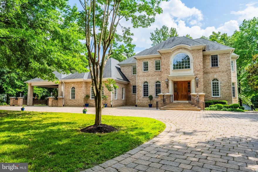 Open House Sunday July 20th 2-4pm. Spectacular custom brick home nestled in the quiet neighborhood of Moore Hill Estates was built with no expense spared in its design. Your stately new home boasts 5 generously sized bedrooms and 5 en-suite bathrooms with 3 additional half baths. This home features room after room of incredible space throughout its almost 9000 sq ft of living space.  Elegance abounds from the circular paver driveway and 4 car garage to the breathtaking 25 ft high ceiling foyer with an exquisite crystal chandelier, grand staircase and elevator. Gleaming hardwood floors grace the upper two levels of the home. Just off of the foyer is a sizeable formal dining room with butler's pantry perfect for guests or holiday dinners.  Across from the formal dining room is a stunning mahogany library sure to envy others. Leading off of the foyer is a large living room complete with a cozy fireplace and coffered ceiling and an absolutely enormous great room/ reception room ideal for hosting events that overlooks the rear patio and private wooded 1+ acre lot. The gourmet kitchen boasts a 60" Sub-zero refrigerator and 48" Thermador gas range, a warming drawer, microwave and wall ovens, built in desk, seating for four at the oversized island and tons of cabinets and counter space.  Sip your morning coffee at the table in the breakfast nook or step out to the fully covered stone patio with a gorgeous built-in fireplace overlooking your private rear yard. Just a few steps down is a multi-level terrace with both covered and uncovered patios for large scale outdoor entertaining at its best. The expansive primary bedroom suite boasts a fireplace, coffered ceilings and a dressing area complete with his and hers walk- in closets/dressing rooms. The Greek inspired primary luxury bath has an oversized soaking tub surrounded by windows, separate shower, dressing table, and water closet. The two secondary bedrooms upstairs are generously sized with spacious closets and en-suite bathrooms. Truly built for entertaining, the sprawling lower level has a fully equipped bar and multiple rooms for entertaining as well as several rooms for storage and a powder room. The recreation room has an impressive brick hearth fireplace and walks out to the beautifully terraced stone patios. Also in the lower level is a huge 4th bedroom with a walk in closet and full bath en-suite. The spacious fifth bedroom is located over one of the garages and also has an en-suite bathroom. Store your gardening tools in a pretty brick shed built to match the home and it even has its own little driveway. Parking is plentiful with a 4 car garage, 4 car carport and a circular drive ample to easily fit another 10+ cars. Close to 395,95, shopping, restaurants and more. Welcome Home!