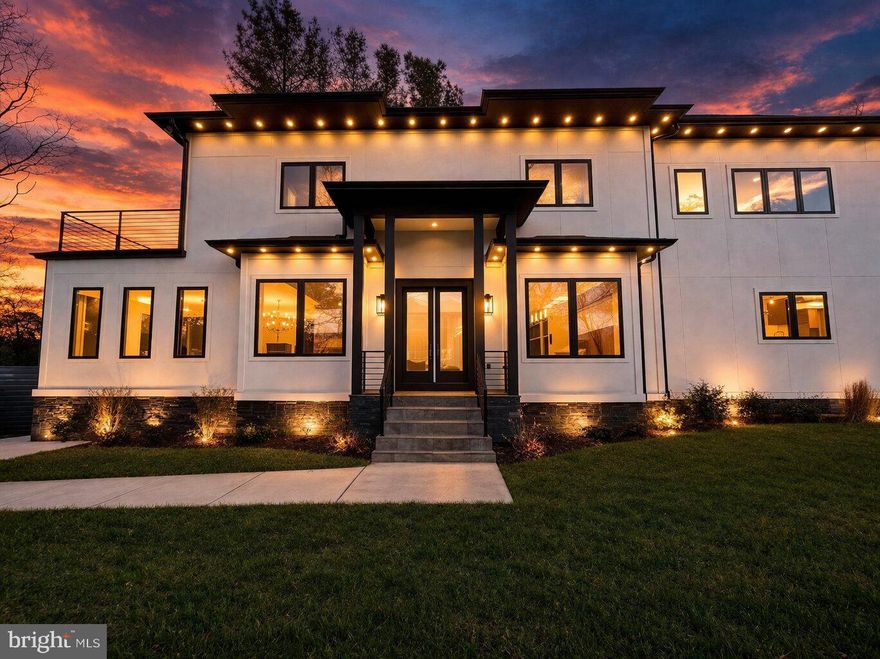 Experience elevated luxury living in this like-new residence showcasing refined craftsmanship, modern elegance, and thoughtfully curated living spaces across multiple levels. Striking architectural lines, expansive windows, and a welcoming front entrance set the stage for the sophisticated interiors within.

The main level offers a seamless open-concept design enhanced by wide-plank hardwood flooring, abundant natural light, and effortless flow between the living, dining, and kitchen spaces. A statement gas fireplace anchors the living area, while the designer kitchen serves as the centerpiece, featuring sleek cabinetry, a waterfall island, premium appliances, and an expansive walk-in pantry. Also, a kid playroom or dog room built in the wall off the kitchen. The adjoining dining area and direct access to the outdoor patio create an ideal setting for both everyday living and upscale entertaining.

Upstairs, the primary suite presents a private retreat with its own balcony, perfect for enjoying peaceful sunset views. The spa-inspired en-suite bath is appointed with a soaking tub, glass-enclosed shower, dual vanities, and high-end finishes. Each additional bedroom offers its own en-suite bath, delivering exceptional comfort and privacy. A conveniently located upper-level laundry room enhances everyday ease.

The lower level is designed for both relaxation and entertainment, featuring a media or fitness room, a full bar with custom cabinetry and sink, and versatile space suited for gatherings or extended living. Multiple fireplaces throughout the home add warmth and ambiance, while built-in elements, recessed lighting, and carefully selected designer details elevate every space.

The fenced outdoor area provides a private backdrop for entertaining or unwinding, with room to personalize to your lifestyle. A two-car driveway and additional street parking offer added convenience.

Ideally situated near I-66, the George Washington Memorial Parkway, and major commuter routes including Glebe Road and Route 120, this home offers seamless access to Washington, D.C., Tysons, and the surrounding Northern Virginia area, along with nearby parks, shopping, and dining.

A rare opportunity to own a like-new luxury home that effortlessly blends style, comfort, and location.