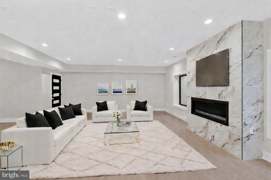 Experience elevated luxury living in this like-new residence showcasing refined craftsmanship, modern elegance, and thoughtfully curated living spaces across multiple levels. Striking architectural lines, expansive windows, and a welcoming front entrance set the stage for the sophisticated interiors within.

The main level offers a seamless open-concept design enhanced by wide-plank hardwood flooring, abundant natural light, and effortless flow between the living, dining, and kitchen spaces. A statement gas fireplace anchors the living area, while the designer kitchen serves as the centerpiece, featuring sleek cabinetry, a waterfall island, premium appliances, and an expansive walk-in pantry. Also, a kid playroom or dog room built in the wall off the kitchen. The adjoining dining area and direct access to the outdoor patio create an ideal setting for both everyday living and upscale entertaining.

Upstairs, the primary suite presents a private retreat with its own balcony, perfect for enjoying peaceful sunset views. The spa-inspired en-suite bath is appointed with a soaking tub, glass-enclosed shower, dual vanities, and high-end finishes. Each additional bedroom offers its own en-suite bath, delivering exceptional comfort and privacy. A conveniently located upper-level laundry room enhances everyday ease.

The lower level is designed for both relaxation and entertainment, featuring a media or fitness room, a full bar with custom cabinetry and sink, and versatile space suited for gatherings or extended living. Multiple fireplaces throughout the home add warmth and ambiance, while built-in elements, recessed lighting, and carefully selected designer details elevate every space.

The fenced outdoor area provides a private backdrop for entertaining or unwinding, with room to personalize to your lifestyle. A two-car driveway and additional street parking offer added convenience.

Ideally situated near I-66, the George Washington Memorial Parkway, and major commuter routes including Glebe Road and Route 120, this home offers seamless access to Washington, D.C., Tysons, and the surrounding Northern Virginia area, along with nearby parks, shopping, and dining.

A rare opportunity to own a like-new luxury home that effortlessly blends style, comfort, and location.