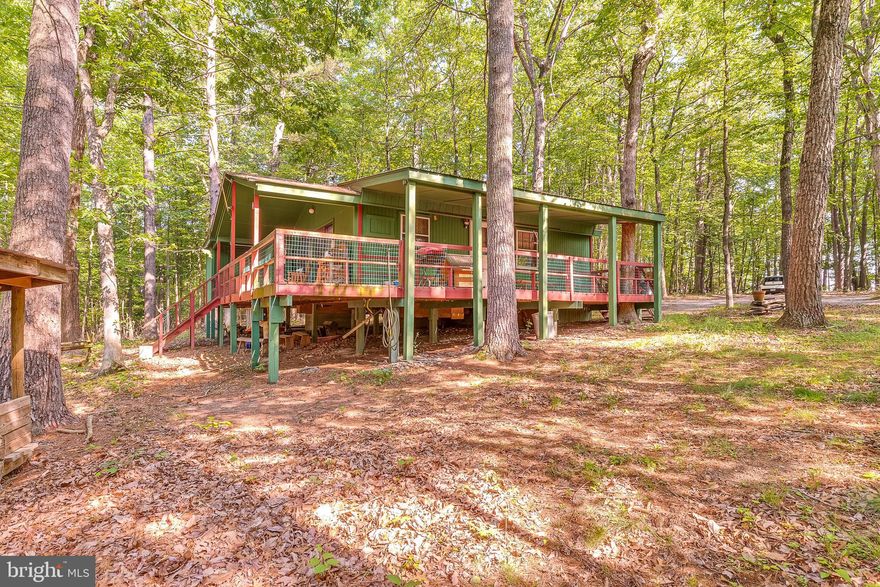 A very special property.  A great little cottage surrounded by 4.31 acres of wooded privacy.  The only neighbors you'll see are the deer, wild turkey and other critters that wander by.  There's a large covered wrap deck to sit and enjoy it all.  At the end of the deck is a tool shed/work shop and all the tools in there convey as does the furniture and appliances in the house.  Large sliding glass doors on the back deck take you inside to the family room with a stone fireplace/woodstove insert - and that's a warm cozy place on chilly days.  There's central AC and heating for comfortable days year round.  Home is being sold as is. Sellers  used the property as a weekend getaway and took good care of the house. They have completed disclosure and aren't aware of any issues with the house.  This is one of those places you love to come home to.  More photos will be coming.  They are packing up so soon as that's done, you'll see how cute the inside is.