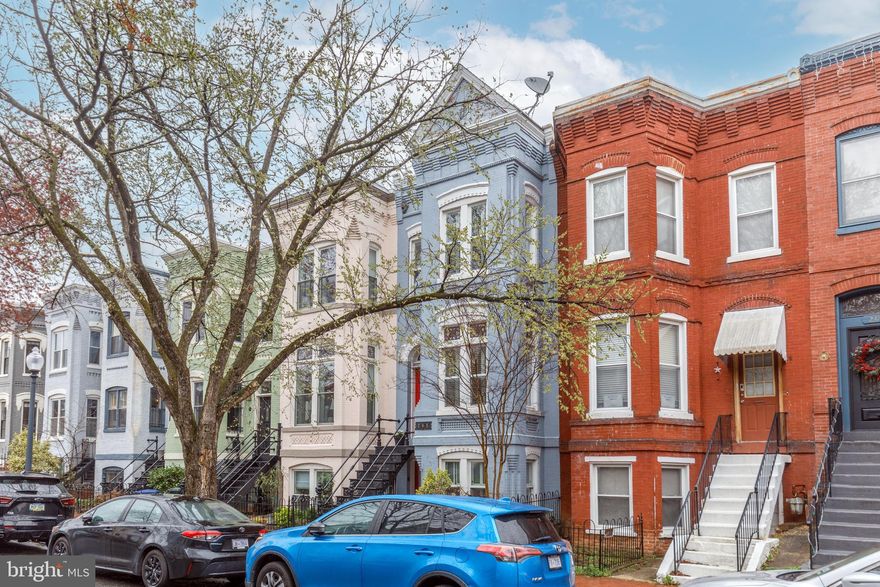 Nestled on a picturesque tree-lined street in the heart of Capitol Hill, this 1927 Federal-style rowhome offers a seamless blend of historic charm and modern updates. With three finished levels, 3 bedrooms, 2 full baths, and 2 half baths, this move-in-ready home is an urban sanctuary designed for both elegant entertaining and 4 comfortable living.A striking ornate façade with intricate detailing welcomes you, while a decorative wroughtiron staircase leads to the grand main entrance. Step inside to find a space filled with natural light, soaring ceilings, and exquisite original details, including hardwood floors, exposed brick, transom windows, and decorative pocket doors that tell a story of timeless craftsmanship.The main level boasts an inviting living room with a wood-burning fireplace, formal dining room, and a wet bar with a mini-refrigerator, perfect for hosting gatherings and a convenient half bath rounds out this floor.On the upper level, the primary suite is a true retreat, featuring plantation shutters, ample closet space, and an en-suite bath with classic finishes. Two additional spacious bedrooms share a second full bath, each room adorned with hardwood flooring and window treatments.The lower level offers additional living space, ideal for a family room or home office and dining with its own cozy fireplace. You will find the gourmet kitchen that is well-appointed with stainless steel appliances, granite countertops, and an island, offering both function and style and it spills out to the backyard. No need to run upstairs, every level has its own bathrooms too. Step outside to an expansive and private backyard, a rare find in the city. Thoughtfully designed for outdoor living, the three-tiered flagstone patios, stone retaining walls, and lush planters create an oasis perfect for entertaining, gardening, or simply unwinding. A storage shed adds practicality, and there is potential to expand the home while still preserving generous outdoor space.This home is perfectly situated just minutes from four Metro stations (Eastern Market, Union Station, Stadium-Armory, and South Capitol), offering unparalleled convenience. Walk to Stanton Park, Lincoln Park, Eastern Market, H Street Corridor, and some of DC’s most iconic landmarks, including the U.S. Capitol, Supreme Court, and Library of Congress. Shopping, dining, and entertainment are all within reach, with Trader Joe’s, Whole Foods, Safeway, and local restaurants just steps away.A rare opportunity to own a historic yet thoughtfully updated home in one of DC’s most desirable neighborhoods. Schedule your private showing today!