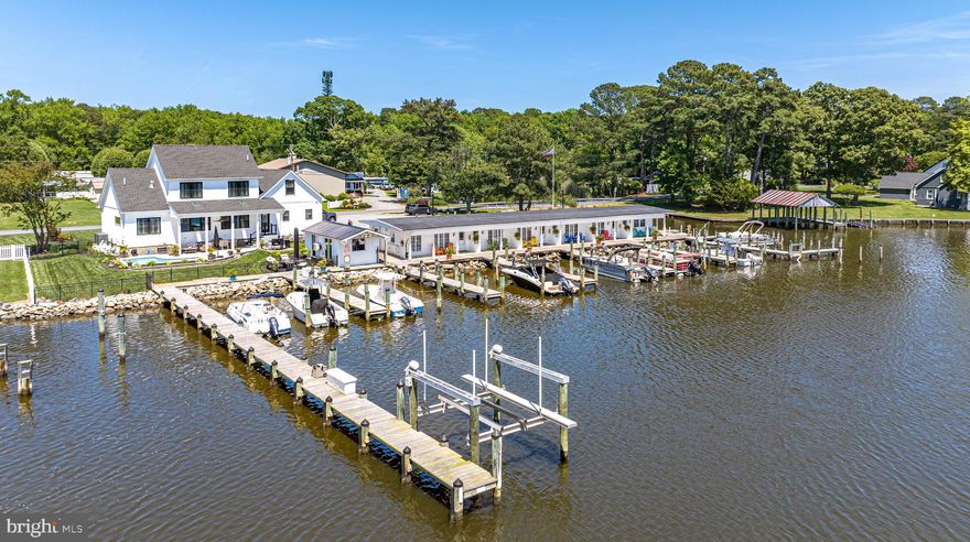 PRICE IMPROVEMENT! Embrace a unique opportunity to own this stunning waterfront property featuring 243 ft of rip-rap along picturesque Turville Creek. This extraordinary property includes a custom-built Main House and a 6-unit Inn currently operating as "The Inn on Turville Creek."
The Inn boasts 6 fully furnished waterfront suites, each with a queen bed, sleeper sofa, kitchenette, private patio, and smart TV. Recently remodeled between 2020-2022, the Inn features new shower stalls, water conditioning system, updated windows and gutters, and an 80-gallon water heater. Guests enjoy amenities such as a kayak and paddleboard launch, picnic area, and lighted off-street parking. The Inn generates rental income with 5 out of the 6 units currently rented.
The property also includes a marina with 22 slips, offering an additional income stream. It's perfect for buyers seeking a primary residence and an investment opportunity or development potential.
The main house, custom-built in 2020 by Poole Contracting, features 3 bedrooms, 2.5 baths, a 2-car garage, open-concept living/dining area with gas fireplace, kitchen with center island, tile backsplash, under & above cabinet lighting, and quartz countertops. First-floor primary suite overlooks the water and includes a custom shower, dual sinks, and walk-in closet with barn door. The second floor has 2 bedrooms, 1 bath, a loft, and bonus room.
The exterior is just as impressive. The rear yard offers a wow factor overlooking the water and marina.  Enjoy a private saltwater pool surrounded by travertine tile, a covered area perfect for outdoor gatherings.  fenced yard, and beautifully landscaped! Your own Tiki bar, "The Backside," offers 294 sq ft of heated and cooled space for entertaining friends and family.
Extra features include a walk-in attic providing excellent storage, a 25,000 kW generator, a 50 amp RV plug, hard-wired window candles, and  irrigation system.
Don't miss out on this unparalleled opportunity to own a waterfront oasis with luxury living and income potential or future development possibilities. 
Contact us today to schedule a viewing and make this amazing property yours! Please respect the sellers' and their guests' privacy. All buyers must be accompanied by a REALTOR and have a confirmed appointment. *Check out the DRONE VIDEO TOUR, click on the video camera icon at the top to watch.