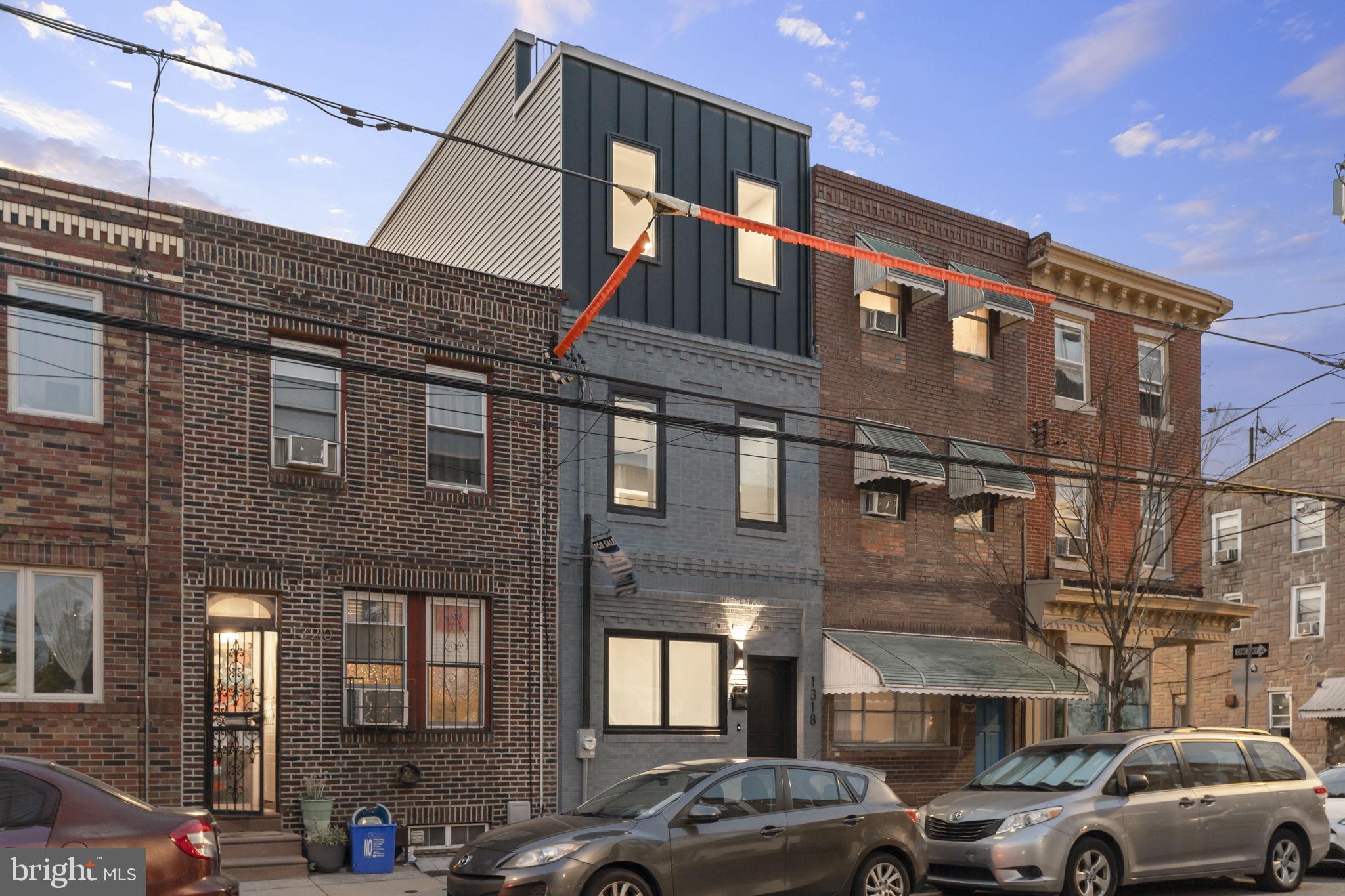Welcome to 1318 S 8th Street, a meticulously designed and fully renovated home in the heart of East Passyunk. Spanning over 2,000 square feet across four finished levels, this 3-bedroom, 2.5-bath residence blends timeless charm with modern elegance—and comes with a full 10-year tax abatement for unmatched long-term value.
The main floor showcases an open-concept living and dining space with custom millwork, wide-plank Dorchester White Oak hardwood flooring, and soft Repose Gray tones. The showstopping chef’s kitchen features white Fabuwood cabinetry, Taj Mahal quartz waterfall island, LG stainless appliance package, pot filler, pendant lighting, and under-cabinet LED accents. A stylish powder room off the kitchen includes navy color drenching, checkerboard marble tile, and Delta champagne bronze fixtures.
Upstairs, discover three spacious bedrooms with recessed lighting, built-ins, and dimmers. The luxurious primary suite offers a walk-in closet with custom cabinetry, a statement millwork feature wall, and a spa-like ensuite bath featuring an arched-entry wet room with freestanding tub, dual vanities, wood-tone cabinetry, and Center City views from the shower.
Additional highlights:
- Expansive roof deck with skyline, bridge, and river views
- Top-floor wet bar with quartz counters and wine fridge—perfect for entertaining
- Finished lower level ideal for media room, gym, or home office
- Laundry room with shaker cabinetry, butcher block counter, and drying rack
- Smart home features: USB-C outlets, dimmers, and Ring camera
- Private rear patio for added outdoor space
- Located steps from East Passyunk Avenue’s top restaurants, shops, parks, and public transit, this home delivers elevated city living in one of Philadelphia’s most walkable and sought-after neighborhoods.