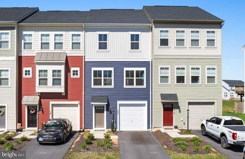 Welcome to this stunning 3-level interior townhome with over 2,000 finished square feet of beautifully maintained living space in sought-after Stephenson, VA! Like new and in excellent condition, this home offers a spacious and inviting layout perfect for modern living. Step into the welcoming foyer and enjoy the lower-level family room with walk-out access to the backyard—plus a convenient half bath. The main level features a gourmet kitchen with granite countertops, stainless steel appliances, a center island, pantry, and abundant cabinet space, all open to a bright dining area and sun-filled living room. Another half bath adds convenience on this level. Upstairs, you'll find three generously sized bedrooms, including a luxurious primary suite with a walk-in closet and a spa-like bath featuring dual vanities, a soaking tub, and walk-in shower. The upper-level laundry makes everyday life easier. Enjoy the benefits of a garage, paved driveway, and a vibrant community with fantastic amenities. Located in the beautiful Shenandoah Valley, this home combines comfort, style, and convenience—don’t miss it!
