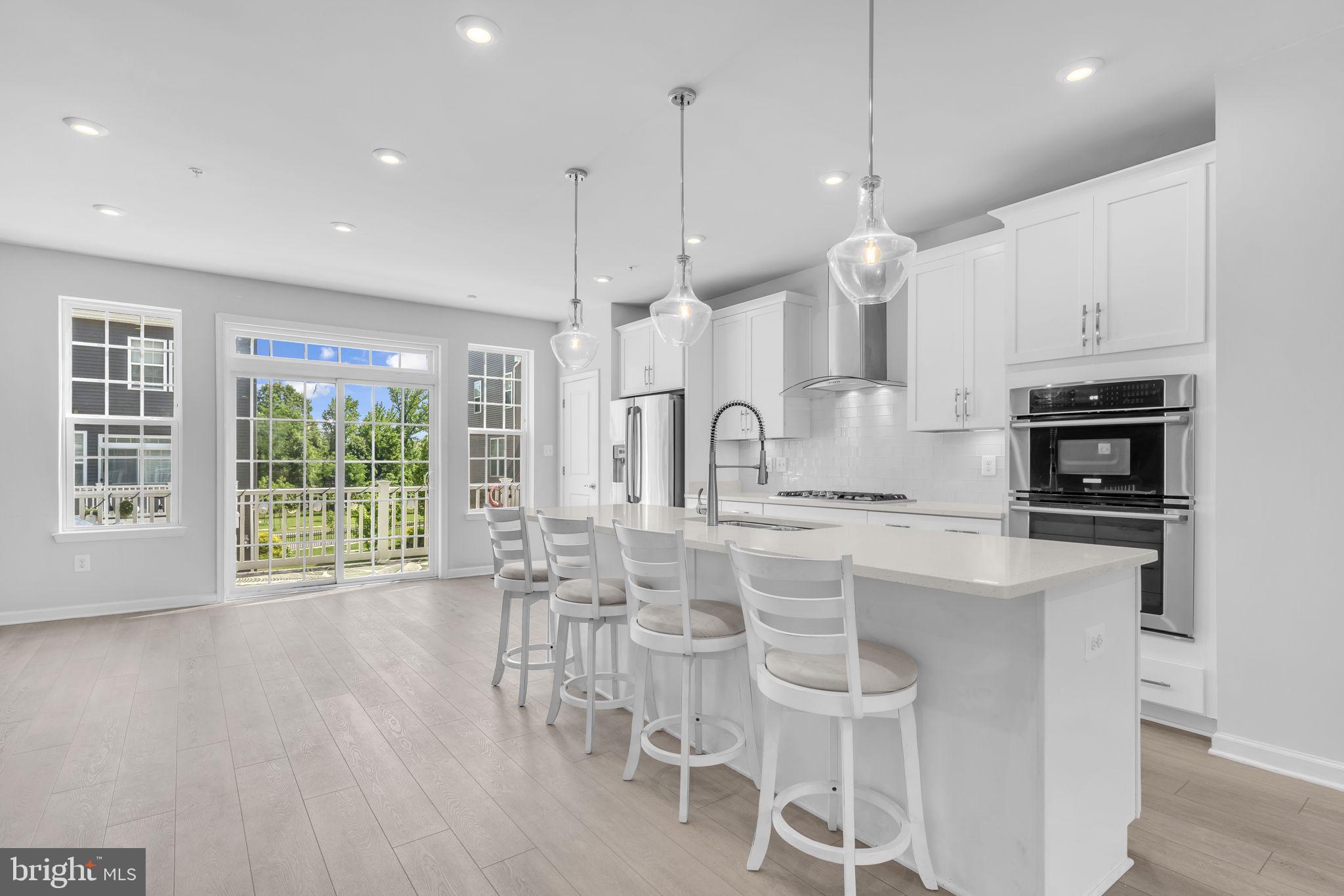 Welcome to this beautifully maintained brick-front townhome in the sought-after Metro Pointe Community, offering over 3,000 square feet of thoughtfully designed living space. This spacious, almost new home features an open floor plan with modern finishes throughout. The expansive main level includes a separate dining area that leads to a sunny balcony, ideal for relaxing or entertaining. The oversized kitchen is a chef’s dream with a large island and breakfast bar, stainless steel appliances, tiled backsplash, and abundant cabinetry. Elegant wood floors flow from the main level into the upstairs hallway and primary bedroom, creating a warm and cohesive feel. The upper level boasts a large primary suite complete with a walk-in closet and a well-appointed en-suite bath. The lower level has a spacious flex space right off of the entry that can be used as an office, family room or 4th bedroom, along with a full bath. Parking is a breeze with an attached two-car garage plus additional driveway space. Ideally located just minutes from Downtown DC, and close to shopping, restaurants, grocery stores, and easy access to Route 50 and the Beltway. A must-see home offering comfort, style, and convenience!
