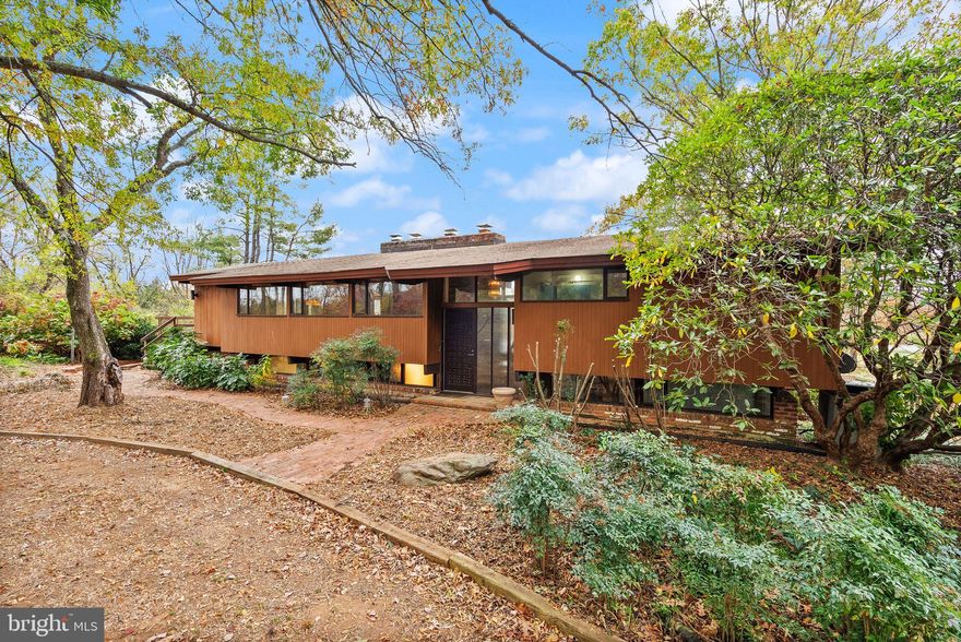 A rare opportunity to own a custom mid-century modern home on a private 6.7-acre setting in Warrenton, VA—complete with a 9,150 sq. ft. conditioned building and a recreational facility:  775 sq. ft. gym/pool house with a full bathroom. This architecturally unique home features vaulted wood-beamed ceilings, walls of glass, and open living spaces that blend beautifully with the natural surroundings. While the home would benefit from some updates, it offers tremendous potential in an exceptional location.
The main level includes a dramatic great room with panoramic views, a floor-to-ceiling brick fireplace, and access to an oversized deck perfect for entertaining or enjoying peaceful sunsets. The open kitchen features natural wood cabinetry and a center island, offering an excellent template for modern upgrades.
The walk-out lower level provides flexible space for recreation, home office use, or guest accommodations. Outside, the property features mature trees, a fenced yard, and an in-ground pool ready for restoration—ideal for creating your own outdoor oasis.

Included on the property is a county-approved 7,800 sq. ft. personal storage/workshop building with a 2nd-floor apartment (1 bedroom, full bath, full kitchen, washer/dryer) plus a 1,350 sq. ft. office/library with full bath and kitchenette. The apartment is approved as a second dwelling (ADU). 

Seller requires a 1-year leaseback for the storage/apartment building.

Additional lots available: VAFQ2019404 and VAFQ2019402

Please request surveys and building plans from your agent.
