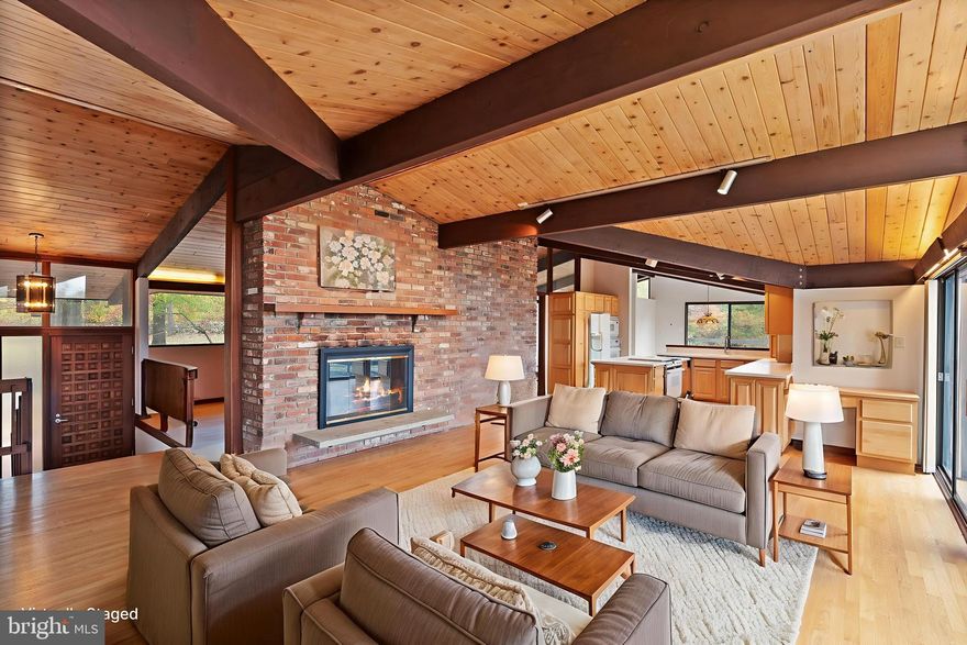 A rare opportunity to own a custom mid-century modern home on a private 6.7-acre setting in Warrenton, VA—complete with a 9,150 sq. ft. conditioned building and a recreational facility:  775 sq. ft. gym/pool house with a full bathroom. This architecturally unique home features vaulted wood-beamed ceilings, walls of glass, and open living spaces that blend beautifully with the natural surroundings. While the home would benefit from some updates, it offers tremendous potential in an exceptional location.
The main level includes a dramatic great room with panoramic views, a floor-to-ceiling brick fireplace, and access to an oversized deck perfect for entertaining or enjoying peaceful sunsets. The open kitchen features natural wood cabinetry and a center island, offering an excellent template for modern upgrades.
The walk-out lower level provides flexible space for recreation, home office use, or guest accommodations. Outside, the property features mature trees, a fenced yard, and an in-ground pool ready for restoration—ideal for creating your own outdoor oasis.

Included on the property is a county-approved 7,800 sq. ft. personal storage/workshop building with a 2nd-floor apartment (1 bedroom, full bath, full kitchen, washer/dryer) plus a 1,350 sq. ft. office/library with full bath and kitchenette. The apartment is approved as a second dwelling (ADU). 

Seller requires a 1-year leaseback for the storage/apartment building.

Additional lots available: VAFQ2019404 and VAFQ2019402

Please request surveys and building plans from your agent.