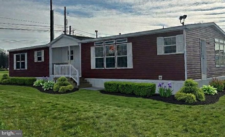 This brand new mobile home offers a spacious 10x20 driveway with additional parking and includes an 8x10 shed for extra storage. Inside, it features central air, a built‑in covered porch, and a modern kitchen with a large island, ceramic tiled backsplash, stainless steel appliances, farm sink, canopy range hood, and a built‑in microwave tower and central air.

The home includes partial drywall, a 4x6 ceramic tiled shower with a glass barn door, a double‑bowl vanity, a huge walk‑in closet, and an office area with a built‑in desk. Additional touches include a recessed tray ceiling, upgraded carpet, black interior hardware, and a high‑efficiency gas furnace.

Practical elements include a utility sink, 28" linen cabinet, coat closet, 50‑gallon electric water heater, and six dining room windows with matching transoms. Exterior upgrades include Hampton Red siding, vertical siding with cedar shake accents, and a stylish overall finish.