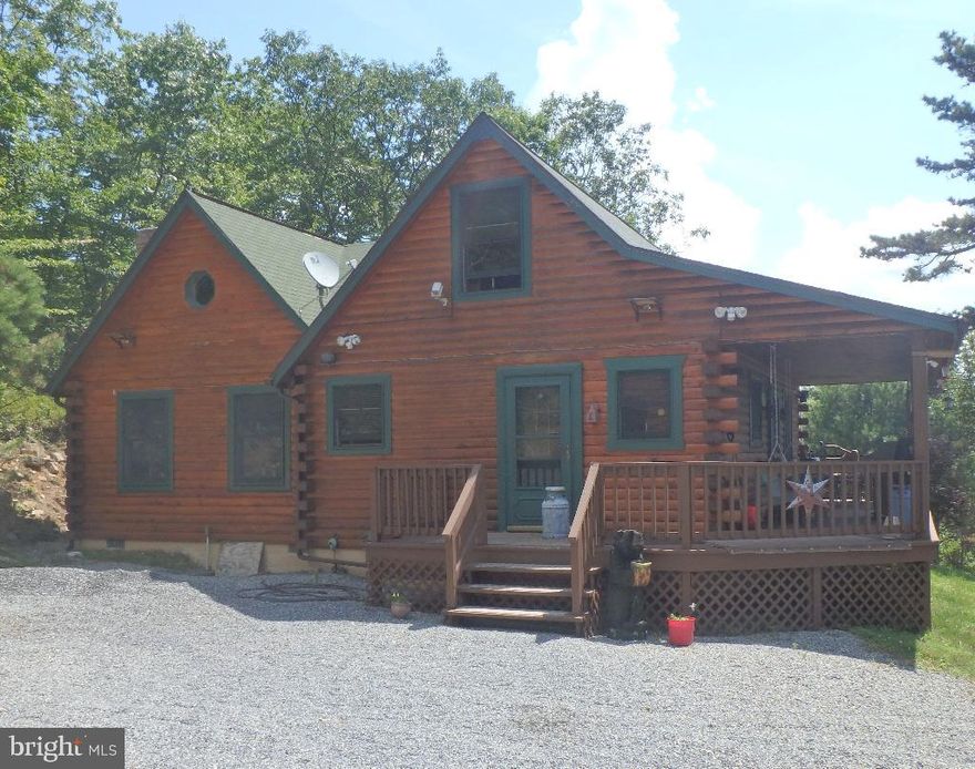 Beautiful, secluded mountain log home with great mountain views located on  5 acres with adjoining 5 acres.  Modernized interior rooms including vaulted ceilings, 2 skylights, granite counter tops, stainless steel appliances, wood burning fire place, heat pump and central air with propane heat for backup. Spiral stair case that leads to a spacious loft for extra bedroom or office.  Master bedroom incudes a bathroom with jetted tub and a laundry area. Guest bathroom with shower and tile floor. 
Property has a septic, mountain spring water and a well.
Huge garage with finished loft that includes heating and cooling.  Extra one car garage could be used for storage, ect... 
Road is maintained through HOA.  Don't miss out on this beautiful West Virginia property!
