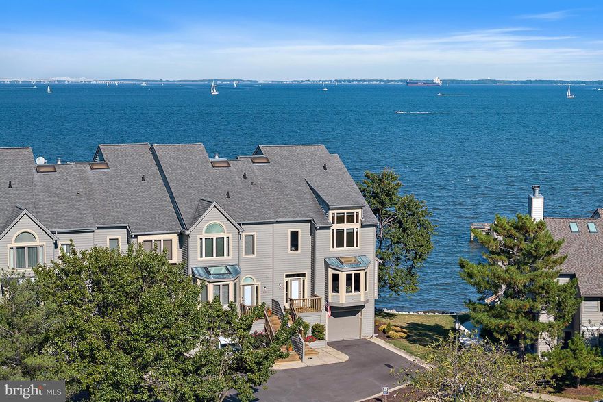 This  end-unit townhome in the gated waterfront community of Chesapeake Harbour offers stunning panoramic views of the Chesapeake Bay and Bay Bridge. With 3,082 sq. ft. across four finished levels and a private elevator, this residence blends luxury, comfort, and convenience.
Highlights include a wraparound main-level deck perfect for entertaining, a living room with fireplace and custom built-ins, and  kitchen with SubZero refrigerator, GE double ovens, granite and Corian countertops, and skylights. The primary suite boasts a private deck with breathtaking Bay views, three closets, and a new (2024) spa-inspired bath with custom cabinetry, soaking tub, and walk-in shower. The loft level offers unmatched views of the Bay along with a full bath, while the finished lower level provides a wet bar, full bath, workshop, and access to a one-car garage with storage plus parking for two additional vehicles.
Major updates include lower-level HVAC (2022), 80-gallon water heater (2021), freshly painted interiors (2025), and multiple window/door replacements.
The community of Chesapeake Harbour offers an incredible array of amenities including: gated and guarded security, professional management, two community pools (one with bay views), tennis courts, walking trails, beaches, a jetty pier, marina, community grills and public waterfront restaurant. Condo and HOA takes care of  landscaping, trash/snow removal, Comcast, and flood insurance. HOA maintains siding, decks, roof (replacement scheduled for 2026), gutters, and annual fireplace/termite inspections. 
Enjoy resort-style living with stunning water views just minutes from Downtown Annapolis in one of  the most desirable waterfront communities. Appraisers: Kitchen and baths (other than primary) needed updating.