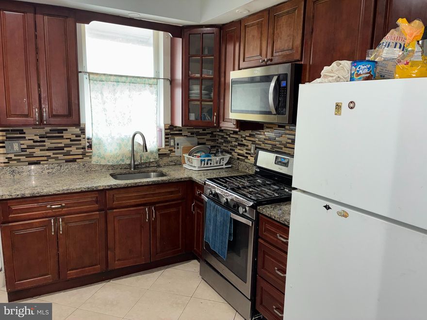 Super spacious home in the heart of Highlandtown. Open floor plan. Main level with 1 bedroom, full bath, living room and kitchen with granite countertops, tall cabinets and newer appliances.  Upper level with 3 nice sized bedrooms and a full bath. Full basement with 3 additional rooms. Freshly painted. Large rear patio with space to park 2 cars. Conveniently located near shops and transportation.