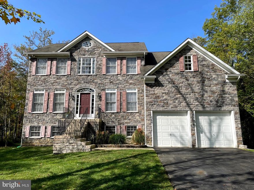 Set back from Chalk Point Road this stone front residence, #5268, is situated on 11.86 acres of wooded land in West River. Over 3100 square feet of finished living space encompassing four bedrooms, first floor office, solarium, expansive spectacular white kitchen- great room with  gas fireplace.  1530 unfinished square footage of additional space awaits your design for hobbies, relaxing space, media, gaming with full windows and walkout sliding door to rear yard.  The  Living room and Dining room are separated by the Open Plan Foyer.  Wood floors grace this home on two levels.    Airy and spacious the vaulted ceiling  owner's suite  features  include two very large walk-in closets and a new luxury bathroom. Choose between the free standing tub or generous sized shower for two. Completing the ensuite bathroom are two separate vanities featuring "touch" mirrors and a private water closet .  Of course there is a bedroom level laundry with sink and cabinets.  The current owners enjoy dining in the  Solarium. From there the added deck overlooks the level rear yard and your extensive  acreage beyond.