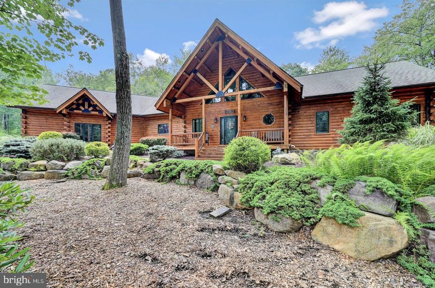 Indulge in the timeless charm of this amazing elegant Pocono Log Home, a stunning retreat nestled in the picturesque Pocono Mountains. This exquisite 4 Bedroom 3.5 bath golf course property seamlessly combines rustic appeal with modern luxury. Designed by Kuhns Bros. The 5100 Sq. feet focal point is the massive grand great room with exposed 6'' x 8'' beams run throughout the entire home. Premium Anderson 400 series windows & Therma Tru doors with Anderson storm doors, 8''x8'' D profile White Pine, Custom window treatments, LED Lighting. All interior partition walls are covered with 8'' tongue & groove white pine. Granite Counter tops with kitchen island, SS appliances, wine fridge, under counter lighting. Interior stairs are all half-log treads with round white pine railing system to lower and upper loft. Primary Bedroom Bath Suite on Main floor. Walk in Closet with built in shelfing. Glass shower. Whirlpool tub. Laundry, Powder room main level. Custom Epoxy Garage Floor,  OLED TVS. Appt. 

Fenced in yard, Hot tub. Timber Tech decking on rear exterior deck and front porch with custom exterior white pine round railing system overlooks #2 T Box with mtn & golf views. Firepit. Sonos sound system throughout home and backyard. Main roof is a timber frame beam and purlin roof system.
Custom alarm system with motion detectors throughout, glass break sensors, temperature sensors, water bug sensors. 22k Whole home Generac Generator, 1000 gallon underground owned Propane tank.

LL Primary w Bath suite & walk in closet. 2 Additional Bedrooms with Baths. Den/Family room. Storage room. Tankless H20, Water treatment system.  Public Water & Sewer. Split Rock owners have access to Lake Harmony Motorboat Lake, Golf, Miniature Golf, Indoor Water Park, Sandy Beach, Lagoon, Pools, Tennis, Boating, Town Center, area Restaurants with JFBB Ski area (A Vail Resorts) minutes away. Please check out the virtual tour.
