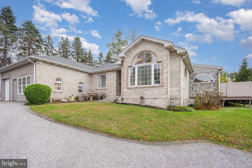 Welcome to this beautiful sprawling rancher with a total of 2900 square feet.  It boasts heated main level floors,  a lovely L-shaped wrap-around sunroom with electric baseboard heat for those cooler days.  This home, built in 1997, is ready for your finishing touches.  It features 3 bedrooms  and 2.5 baths.  It could easily have more bedrooms upstairs in the large finished upper level with lots of cabinets and storage including a nice cedar closet.  This home also also features  a first floor laundry,  a large, bright eat-in-kitchen with step down into dining area with built-ins and a nice sized living room area.  On other side of home there is a master suite and 2 additional bedrooms. The 2 car oversized garage, also with a heated floor is roomy and  the driveway has plenty of area to park your vehicles and it wraps around to the back of the home. The basement is large, open and unfinished. The home has a newer (last year) roof, skylights, a hot water heater. With LOTS of light and lots of character, and a bonus wrap around deck,  don't wait!  Come and see why you should make this home yours  before someone else does!