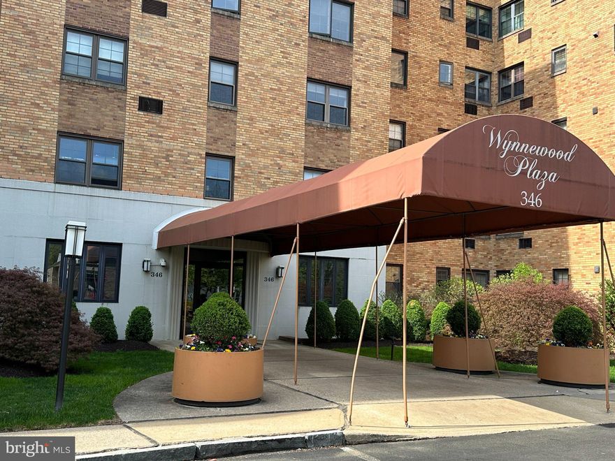 A prime location and excellent condition make this very large, corner one bedroom a great choice for your new home. The 1152 sq ft condo is in move in condition with renovated kitchen, newer bathroom, and hardwood floors. It was recently painted in handsome neutral colors. This property is located within walking distance to Whole Foods (across the street), restaurants, shops, Wynnewood train station (.3 miles), and the Village of Narberth. As you step into the huge foyer, you will be amazed at how bright the ceiling lights make the foyer, hall and living room. To the right of the front door is a generous closet for coats and storage. The living room is approximately 22 ft long with light streaming through big windows. To your right is a corner dining room with exposure on two sides giving you fresh air and light. The charming kitchen with high hat lighting is renovated and easy to work in with cabinets reaching to the ceiling, updated appliances and a window. You will love the 5-burner gas stove, the Touch Bar faucet and generous storage. The primary bedroom is quite large, approximately 18 x 20 feet with a big walk-in closet. The newer bathroom has a walk-in shower with safety bars, high hat lighting and a washer & dryer. Take the elevator up one flight to see the roof top deck furnished with tables and chairs. This 5th floor of Wynnewood Plaza is scheduled to be renovated (carpets, painting etc). The assessment for that has already been paid by sellers. Go to the 3rd floor to see how it will look, as an example. This 5th floor of Wynnewood Plaza is scheduled to be renovated (carpets, painting etc). The assessment for that has already been paid by sellers. Go to the 3rd floor to see how it will look, as an example. There is a library, social room, work out area, and a storage locker in the lower levels. When available, there are garage spots for rent for $72/month. There are numerous activities posted on a board in the mail room to participate in at your leisure. Electricity is only utility an owner pays since all others are included in the monthly fee of $621.61. Move in fee is $250.    Capital contribution is $1243.22.