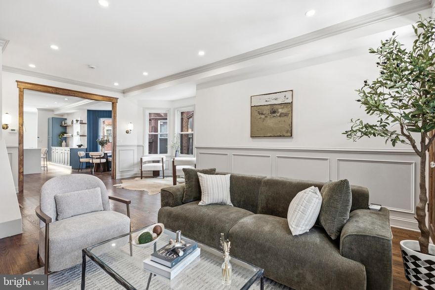 Scale, craftsmanship, and architectural detail throughout immediately announce this is not a typical renovation. Discover an unbelievable 20x102 lot with over 2,500 finished square feet plus extraordinary custom outdoor space rarely found in the city. Repointed brick façade with rich charcoal trim, sleek architectural sconces, covered front porch with paneled soffit ceiling, modern square columns, and solid-pine entry door create arresting curb appeal. Inside, soaring 10’ ceilings, exposed brick, solid oak floors, elegant shadowbox millwork, crown molding, integrated linear fireplace, and custom recessed shelving wrapped in warm-stained wood unfold beneath magnificent front-to-back natural light. Dramatic bay-window seating flows into beautifully finished living and dining spaces anchored by oversized waterfall island, warm brass statement lighting, saturated-blue custom cabinetry with undercabinet glow, textured backsplash, crisp quartz surfaces, farmhouse apron-front sink, freestanding hood, open shelving, and dedicated dining nook framed by bold paneled millwork. Bright rear mudroom wrapped in designer wall covering with slate flooring, custom bench seating, and beautifully finished powder room featuring vessel sink and brushed gold hardware. Step out to sprawling 38’ deep patio and garden with newly poured concrete decking, landscaped beds, custom wrought-iron stairs, and towering privacy fencing - extraordinary outdoor scale rarely found at this price point. Custom wrought-iron staircase with polished wood banister and cascading spherical chandelier leads to generous guest quarters drenched in natural light. Hall bath featuring furniture-style double vanity, patterned flooring, deep soaking tub wrapped in Caribbean-blue tile, plus convenient second-floor laundry with Samsung front-loading washer and dryer. Boutique-hotel-inspired owner’s retreat with exposed brick, stained beam detail, antique pendant lighting, integrated display ledge, custom closet organizers, and exceptional scale throughout. Frosted barn door opens to spa bath featuring stained solid-wood double vanity, vessel sinks, freestanding soaking tub, decorator sconces, and expansive walk-in shower wrapped in mosaic flooring and soft blue tile accents beneath matte-black framed glass. Fully finished waterproofed basement with exposed stone accent wall, white-oak flooring, permitted fourth bedroom, and beautifully finished full bath with Carrera marble floors, artisan tilework, and frameless glass enclosure. All-new mechanicals, roof, and windows. A level of finish, character, and architectural personality rarely found anywhere near this price point. Shows beautifully.