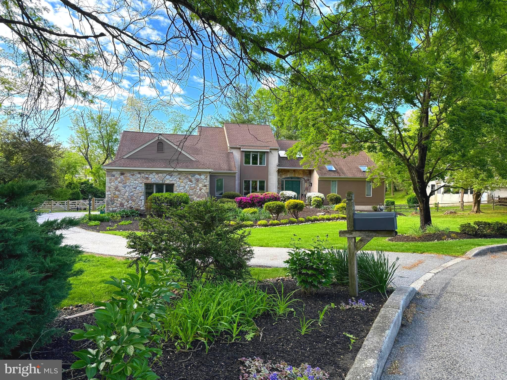 This superb 4-bedroom 2.5 bath Contemporary home is ideally situated on a gorgeous beautifully landscaped one plus acre lot at the end of a cul-de-sac in the very sought after prestigious development of Spring Oak Estates. This open floor plan features a grand entry with skylights and new modern light fixture and freshly painted staircase with new carpeting. A very comfortable flowing freshly painted first floor primary suite with new luxury flooring and sunny ensuite with separate glass shower area with sliding doors, skylights and even a tv if you care to really hang out and relax while soaking in the jacuzzi tub after a hard day or maybe just because! Living room is generously sized and also freshly painted with new carpeting and features a stylish marble fireplace and skylights with vaulted ceiling looking up to the second story hall. Gorgeous kitchen loaded with cabinet space including stainless steel appliances and (refrigerator included) gleaming granite counter tops with breakfast bar. Family room has 2 huge sliding and French doors with retractable screens allowing it to fill with sun and fresh air and make you feel like you are virtually outdoors, but still in the comfort of the inside and lead to a cedar deck with such pretty views and stairway to partially fenced rear and side yards. Off hall of the kitchen is a nice sized pantry closet area and freshened powder room and continuing down hall is the bright laundry room with included washer and dryer and garage entry. The newly painted family room boasts soaring vaulted ceilings with beautiful cross beams, large ceiling fan and a stately floor to ceiling stone fireplace, A beautiful wood spiral staircase adds so much interest and leads up to a large loft area for a possible exercise room or home office and looks down onto the family room. The nicely sized formal dining room makes its statement with freshly done neutral painting and wainscoting and crown molding and new modern light fixture and larger bay window overlooking the front yard allowing you to adore the beautiful trees and flowers in the front yard. The second floor has three all nicely sized bright bedrooms and closets with recessed lighting and ceiling fans and ample closet space. All are freshly painted and newly carpeted. Finished daylight walk out basement with spectacular hand-crafted fireplace and additional huge storage areas. Central heat and a/c with heat pump economy and tankless water heater! New split rail wood fence in partially fenced in yard. All this and an award-winning Rose Tree Media school district and open spaces and lower taxes. Well maintained and ready to move in condition make this property a no brainer along with being the envy of your friends and family. This location is perfect, with its rural serene setting yet within less than a few minutes you are in downtown Media with all it also has to add and offer. Will not last!