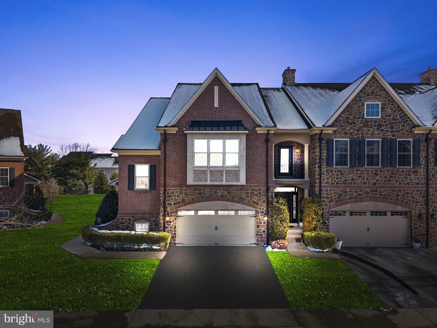 Beautiful end-unit townhome in desirable Walden Square, offering thoughtful upgrades, meticulous maintenance, and exceptional natural light throughout. From the welcoming covered porch, step into an inviting foyer graced with wainscoting, abundant sunlight, and a striking three-level craftsman staircase. Gleaming hardwood floors lead through the main hall, flanked by an inspiring home office or study and an entertainment-sized dining room—ideal for both formal and casual gatherings. At the heart of the home is a spacious open-concept living area, featuring a sun-filled living room with gas fireplace and tall windows offering tranquil green views. This space blends seamlessly into a stunning gourmet kitchen with an oversized center island, Monogram built-in appliances, a commercial-style six-burner cooktop with stainless steel hood, beverage cooler, and custom Carrara marble backsplash. An exceptional amount of cabinetry provides both beauty and functionality. In addition to generous island seating, the kitchen opens to a bright breakfast area with a French door leading to an elevated sun deck overlooking the lawn. This level also includes a stylish powder room. On the upper level hardwood floors continue throughout, including the spacious primary suite with sitting room, twin walk-in closets, and a luxurious en-suite bath with oversized shower, soaking tub, double vanity, private water closet, and linen closet. The owner’s suite enjoys serene lawn views, while fine moldings and hardwood flooring elevate every room on this level. A large laundry room with sink and upgraded appliances is conveniently located nearby, along with a beautifully appointed hall bath serving two additional bedrooms—each with large windows and ample closet space, including a “VIP” bedroom with its own walk-in closet. The three-level staircase connects to a finished English-style daylight basement offering a large media area, space for billiards, gaming, or exercise, oversized windows, tray ceiling, and a custom wet bar. A beautifully finished full bathroom and generous storage/mechanical room complete this level. This exceptional home is loaded with upgrades including fine moldings, recessed lighting, multi-zone high-efficiency HVAC, and a two-car garage. Its premium end-unit location provides abundant windows, exceptional natural light, and open green views from key vantage points—making this a special opportunity for a carefree lifestyle in Newtown.