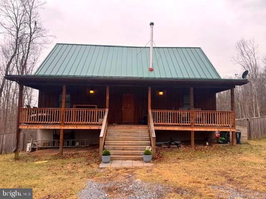 CUSTOM-BUILT 2016 CABIN  WITH NO HOA FEES, UNRESTRICTED & CAN DIVIDE THE 10.33 ACRES INTO 2 PARCELS, IF WANTED.  MAINTENANCE-FREE  METAL ROOF.  THE MAIN LEVEL HAS AN OPEN FLOOR PLAN WITH  LIVING SPACE OF 2,271 SQ, FT.  NESTLED IN A PRIVATE SETTING ON 10.33  ROLLING ACRES.  THE  FULLY POURED CONCRETE BASEMENT  IS MOSTLY FINISHED, WITH AN OFFICE AREATREES SURROUND THE PROPERTY WITH TOTAL PRIVACY.     THE HOME IS INSULATED WITH HYPOALLERGENIC WOOL INSULATION. WOOD INTERIOR W/ HARDWOOD FLOORING.  OPEN FLOOR PLAN ON MAIN LEVEL.  WOOD-BURING STOVE ON MAIN LEVEL, PROVIDING WARM HEAT FOR BOTH LEVELS.   THE GOURMET KITCHEN HAS A SPACIOUS ISLAND WITH SILESTONE COUNTERS, STAINLESS STEEL APPLIANCES: GAS OVEN / RANGE HOOD. DISHWASHER, W/ INSTANT HOT WATER, REFRIGERATOR.  WASHER/DRYER.   THE GREAT ROOM HAS A WOOD-FIRED STOVE ON THE MAIN LEVEL, WHICH ALSO WARMS THE UPPER LEVEL.  THE HVAC UNIT PROVIDES  A SECOND OPTION FOR HEAT/AIR.  THE SPACIOUS UPPER LEVEL IS  A PARTIALLY OPEN ROOM, WHICH COULD CONVERTED INTO AN ADDITIONAL BEDROOM.  THE CABIN HAS 3 LEVELS :  MAIN LEVEL AND UPPER LEVEL  AND THE FULL BASEMENT WHICH PROVIDES 2-3  BEDROOMS, WITH  A BATHROOM ON THE LOWER LEVEL, ALONG WITH  THE LAUNDRY AREA. WITH  THE WINDOWS HAVE INSULATED DOUBLE PANES / ENERGY EFFICIENT.   THE LOWER LEVEL HAS THE WASHER / DRYER, SHELVING AND STORAGE SPACE. HVAC UNITS FOR HEATING AND COOLING.    WORK FROM HOME?   YOU'LL HAVE THE BEST WITH FIBER OPTICS!!  THERE'S AN AREA  FOR THE 
RAISED BEDS FOR VEGETABLES AND FLOWERS. CREATE YOUR OWN FARMETTE!  PLENTY OF DEER & OTHER WILDLIFE TO ENJOY. HUNTING ALLOWED.  RAISE CHICKENS  &  GATHER YOUR OWN FRESH EGGS.  COWS & HORSES, ARE  ANOTHER OPTION.   LARGE METAL GARAGE FOR VEHICLES/ STORAGE, WOOKSHOP! WOODSIDED SHED, WITH ELECTRIC AND PELLET STOVE & 2 PORTABLE AC UNITS AND CAN BE CONVERTED INTO A SEPARATE QUAINT CABIN.  WELL & SEPTIC.  POURED CONCRETE FOUNDATION WITH FULL BASEMENT WHICH IS  80% FINISHED.  HAVE PETS?   THE BACK OF THE HOME  HAS A  FULLY-FENCED YARD!  GREAT LOCATION AND GOOD ACCESS.     PERFECT FOR RIDING ATV'S.  YOU'LL ENJOY  SCENIC DRIVE TO THE PROPERTY.  FRONTS A COUNTY ROAD.  ONLY 3/10  MILE ON A SECONDARY RD. TO THE PRIVATE DRIVEWAY.  NOT A FULL-TIME RESIDENCE... PERFECT FOR ABNB RENTAL, TOO.   DO WHAT YOU WANT ON OVER 10 ACRES!   APPROX. 2.5 HRS.  TO THE DC / BALTIMORE  METRO AREAS.