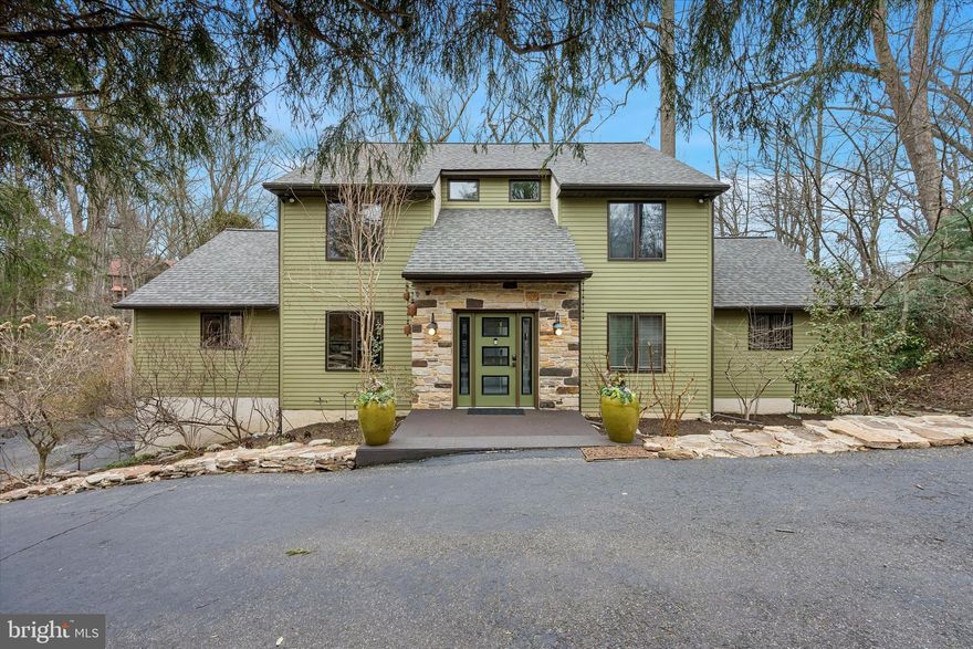 From the moment you step inside 2 Lake Avenue, you will appreciate the abundance of natural light, uniqueness, and the artistic quality of this home. This beautifully situated property offers generous space, flexibility, and a serene natural setting on nearly one acre (0.94 acres) in the desirable Wallingford-Swarthmore School District. 

Set on a picturesque lot overlooking a peaceful creek, this 4-bedroom, 3 full and 1 half-bath residence offers both privacy and convenience, with easy access to transportation and nearby amenities. Stepping inside, the spectacular Living Room draws your eye as it rises to the soaring open ceilings, creating an extraordinary sense of space. Full of oversized floor to ceiling windows that frame beautiful outdoor views, this room is anchored by a large fireplace, lending it style and warmth. Just off the Living Room is a bright and whimsical Craft Room with sliders to the deck, this wonderfully versatile space could be equally suited as a home office, studio, or hobby room. The oversized Eat-in Kitchen with ample custom oak cabinetry and large pantry, is both beautiful and functional, and is perfect for both casual family dining and impressive entertaining.  It flows naturally into the expansive Family Room, where walls of windows and sliders to the expansive multi-level decks offer breathtaking views of the mature trees in the backyard and sweeping lawn beyond. The first-floor Primary Suite offers new carpeting, a refreshed en-suite bathroom, and a large walk-in closet, as well as a balcony. There is also a powder room and Second Bedroom on the first floor, which is currently enjoyed as a home Office.  

Upstairs, the second-floor balcony overlooks the Living Room below, offering a stunning bird's-eye view of the soaring ceilings and scenic outdoor views. Two generous Bedrooms and an impressive updated Hall Bathroom are thoughtfully arranged adjacent to an open area, perfect for an additional family room, study space, or playroom. There is new carpeting on the stairs and throughout the second floor. There is also a large unfinished space, currently used for wonderful storage, but could be finished into an additional bedroom, guest suite, or bonus room, adding tremendous value and versatility to this home.

The fully finished, walk-out Lower Level is fabulous, and offers another wonderful recreation space and has plumbing for a kitchenette or bar area, an ideal setup for an in-law suite, au pair quarters, guest space or private office space, as this floor can be accessed directly from the lower portion of the driveway and the attached one-car garage. With a full bathroom and easy access to the fabulous deck and yard , this space is also perfect for entertaining and enjoying the pool table, shuffleboard and pinball machine with family and friends.  A cedar closet, laundry room, and unfinished storage area complete the lower level.

Whether hosting outdoor gatherings, enjoying a quiet evening surrounded by nature, playing games, or simply taking in the view, the outdoor space is exceptional and provides a rare and peaceful retreat for exploration and enjoyment.  A highlight, in addition to the sweeping views, is a very special custom-built Treehouse that appears to be out of a storybook, in addition to two fire pits for your outdoor enjoyment. A new roof installed in 2026 provides added peace of mind for years to come.

Despite its tranquil setting, the home is remarkably convenient. The Moylan–Rose Valley Station is accessible from the neighborhood, making commuting simple. You are also just minutes from the shops, restaurants, and community events in Media Borough, and you have easy access to Philadelphia International Airport.

Offering tremendous living space, flexibility, and a beautiful natural setting in a highly convenient location, 2 Lake Avenue is a wonderful opportunity to create your next chapter.