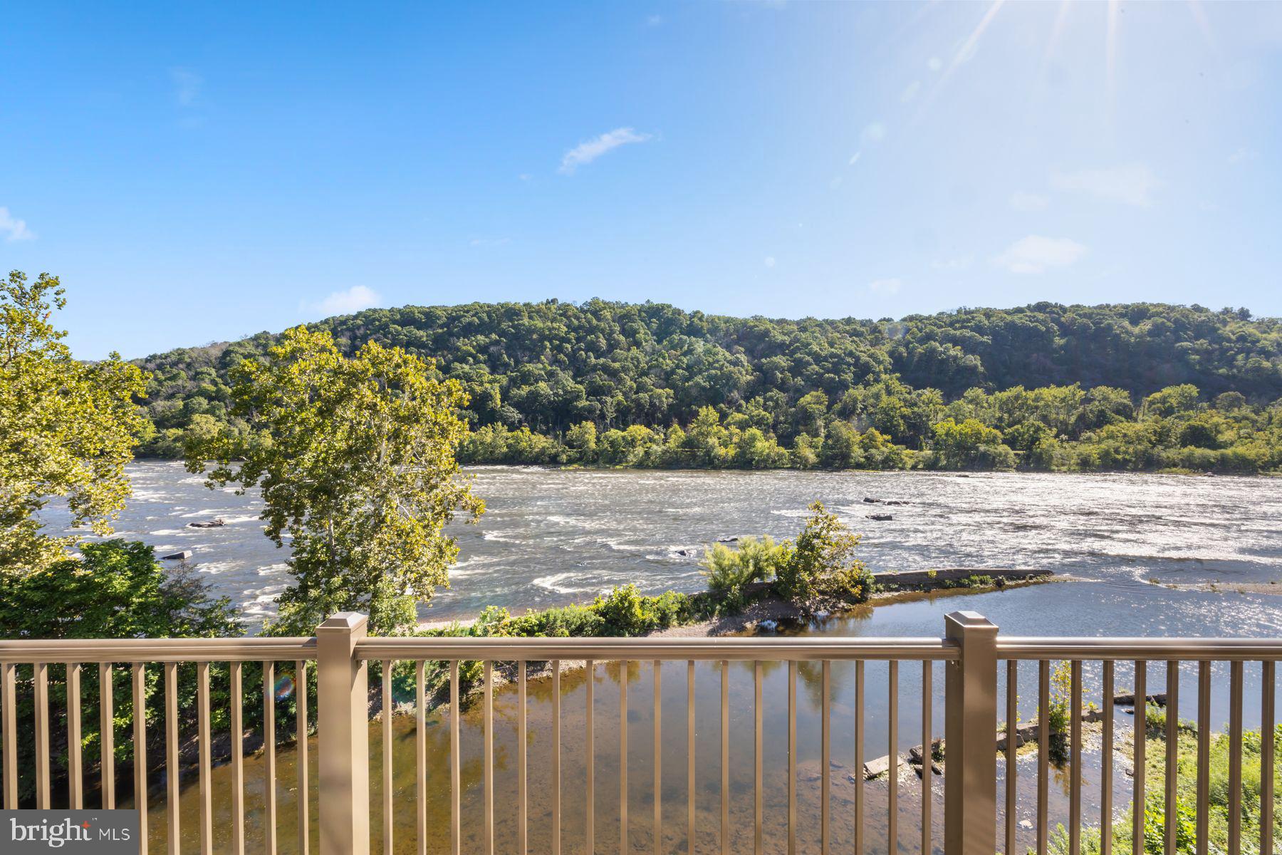 Waterview – You’ll feel like you’re on top of the world in this stunning, newly renovated luxury Penthouse at New Hope’s most prestigious address. The 5 Bedroom, 4.1 Bath two-story condominium enjoys unrestricted views of the Delaware River, while offering a carefree, turn-key lifestyle with state-of-the-art finishes. A keyed entry shared with only 3 others takes you by elevator directly into your own residence. The entrance hallway leads to an open floor plan showcasing the living room with newly designed fireplace, and dining room with cove lighting and new lighted glass cabinetry. Both share a floor to ceiling wall of windows and access to a spacious outdoor terrace (one of three). The first floor has been updated in a sophisticated modern style, with new wire brushed white oak flooring, and a light and airy palette. The cooks’ kitchen with new quartzite counters and backsplash has new antiqued brass faucets and fixtures. It is equipped with high end appliances including a Wolf 6-burner cook top with griddle, Thermador double wall ovens, a Subzero refrigerator/freezer, Miele dishwasher and there is a conveniently located laundry. If not dining in the main dining room, the comfortable family area with fireplace and a terrace joins with the open kitchen with breakfast bar and stools - a great space for casual enjoyment. A handsome home office with teak ceiling is outfitted with a wet bar and new quartzite counters, 2 wine coolers, and a hammered brass sink. The updated powder room is nearby. The first-floor main bedroom suite is truly a retreat, with a designer dressing closet, full bath with steam shower, custom shades, and a private terrace. A sunny office with bay window is a great adjunct to the main bedroom suite with river views in every direction. Take the newly redesigned staircase to the 2nd floor, complete with new railings and tempered glass panels, or use the private cherry- lined elevator. Upstairs, a two-story great room/studio is a fabulous multi-purpose space with two-story windows to the river, complete with a new quartzite serving counter with sink, two refrigeration drawers, and an icemaker – truly an inviting space for entertaining family and friends, or an outstanding light-filled art studio, as it is presently being used. There are 4 additional bedrooms and 3 baths, one bedroom presently being used as a home gym. All bedrooms have new high-end carpeting. Exceptional style and a sensible floor plan are the hallmarks of this well -designed home, which features new high hat and designer lighting, new Springboard electronics and music, a new Savant home automation system, new thermostats, and zoned heat and air conditioning. This premier, luxury community offers direct access to the canal towpath for hiking, biking, and fishing, and there is garaged parking for two cars and additional parking for guests. New Hope is just minutes away by walking or biking, where there are favorite eateries, eclectic shops and bars, and the renowned Bucks County Playhouse. For commuting, this exceptional home is easily accessible to Princeton, Philadelphia, New York and airports. From your perch overlooking the Delaware River, enjoy endless views and the sights and sounds of nature. No stone has been left unturned in the renovation of this gem of a home. It is simply sensational!
