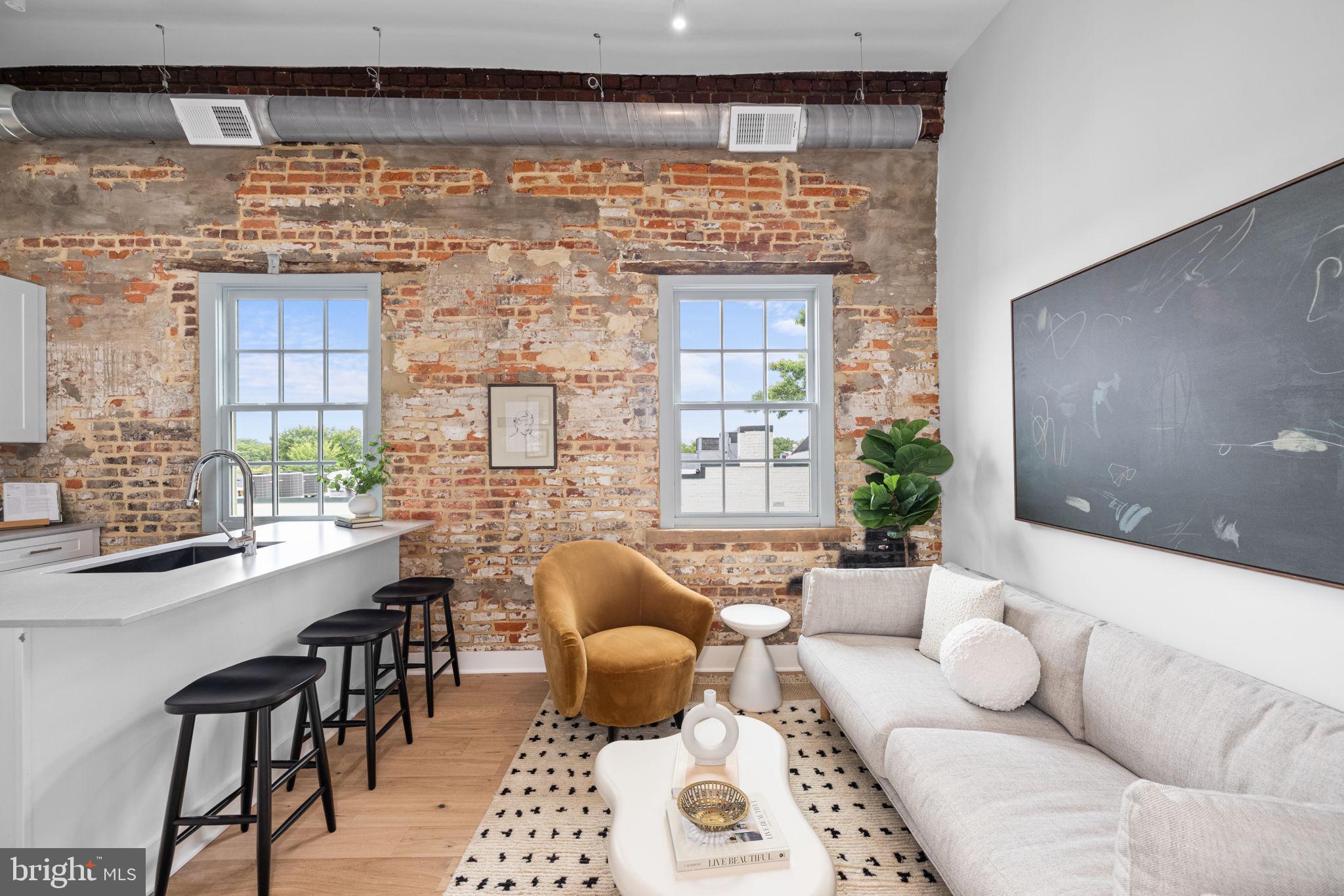 Nestled in the heart of Old Town Alexandria, this charming 1 bedroom, 1 bathroom apartment offers a perfect blend of historic charm and modern luxury. Featuring one junior bedroom and a well-appointed bathroom, the residence boasts exposed brick walls that add character and warmth to the space. The kitchen is a culinary dream with a spacious island and luxury finishes. Experience the rooftop deck with breathtaking views, providing an ideal space for unwinding or entertaining outdoors. The in-unit washer and dryer add convenience to your daily routine, and the building offers both elevator access and a modern community gym for your fitness needs. If you require additional room, paid storage solutions are available. Parking is conveniently located nearby for rent, ensuring easy access to your vehicle. This rental offers more than just a residence—it’s an elevated way of living. Immerse yourself in the historic charm and vibrant lifestyle of Old Town Alexandria, making this exquisite home your perfect urban retreat. Please note that the staged photos shown are of a similar unit and may not reflect the exact features or layout of the available unit. Rental Special - enjoy 1 free year of internet (99/month)